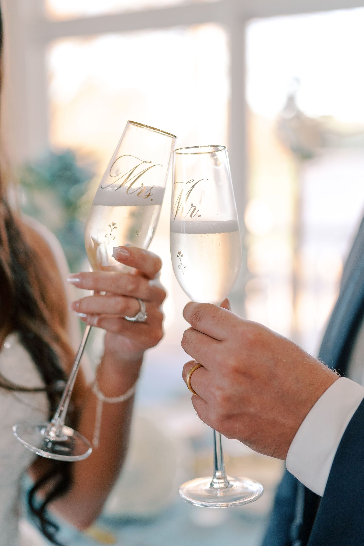 Wedding guests toasting with champagne glasses in a celebratory moment.