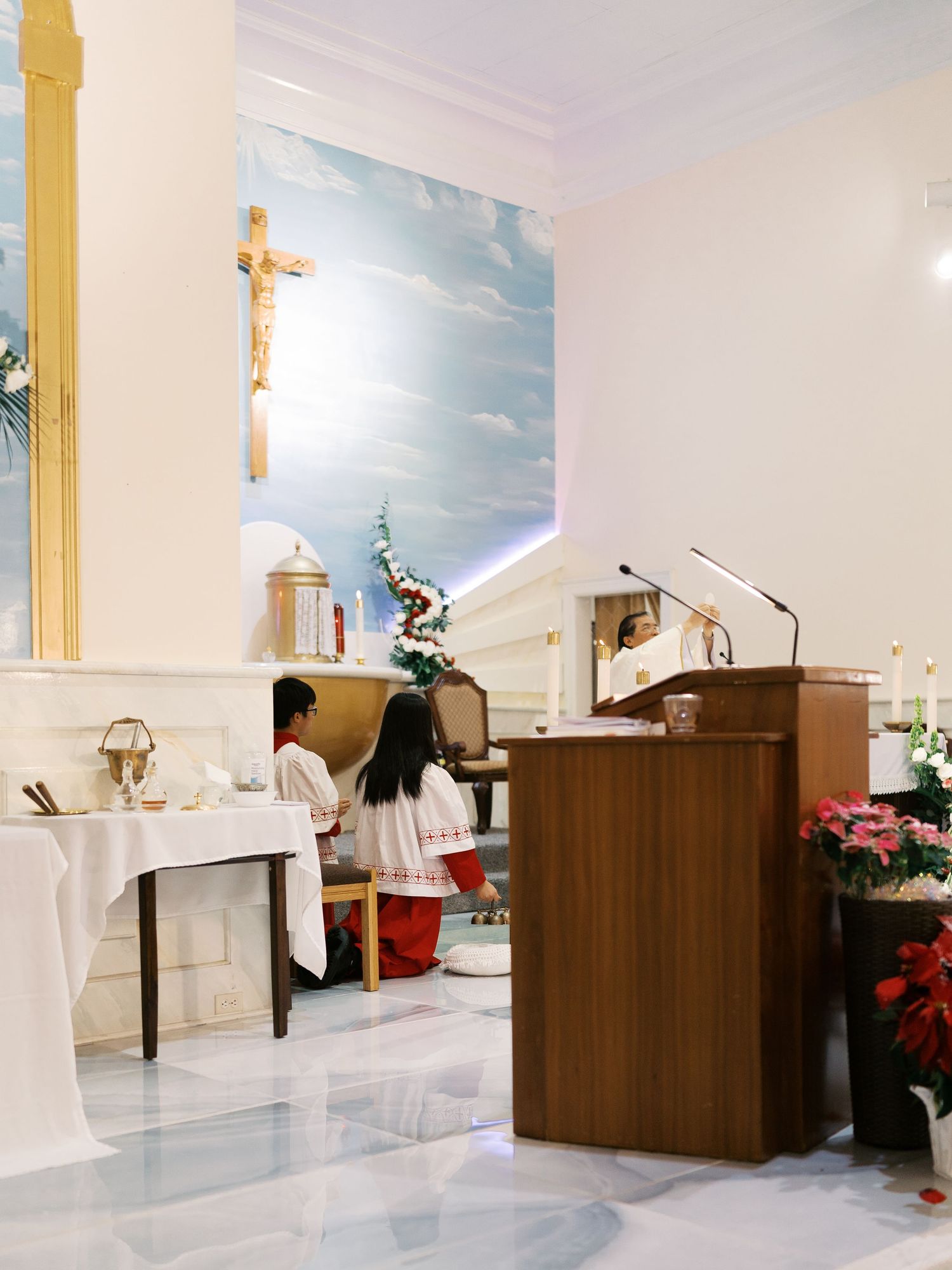 Modern church sanctuary with wooden podium and white decor for a wedding ceremony.