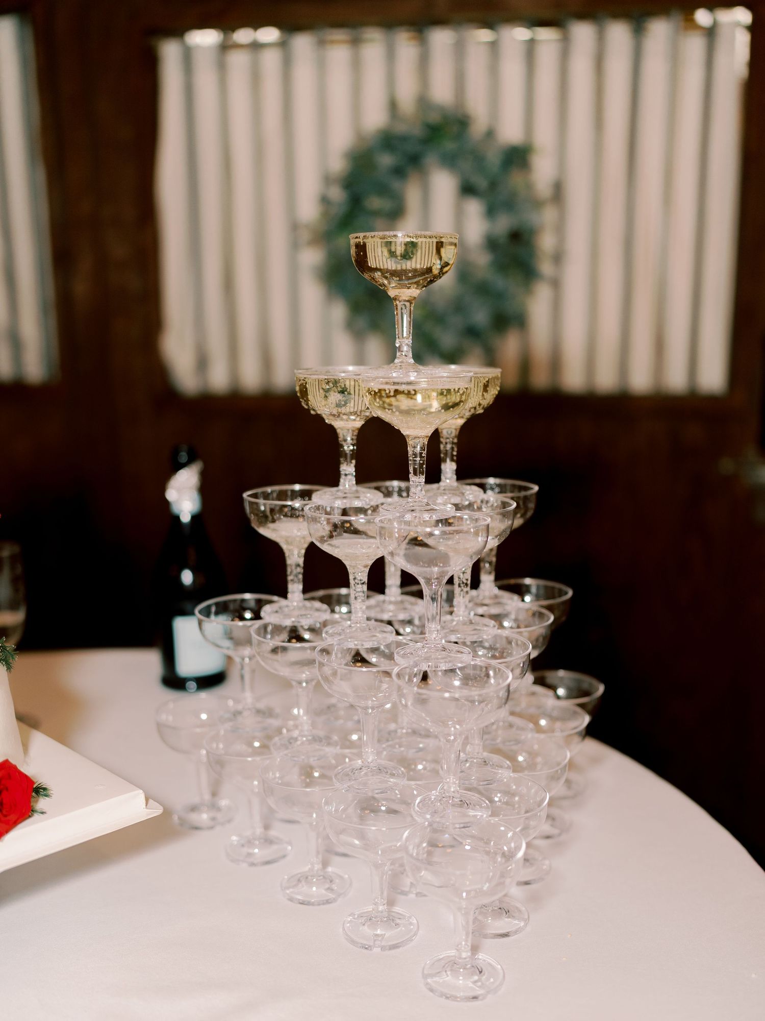 Elegant tiered champagne glass tower setup at a wedding reception.