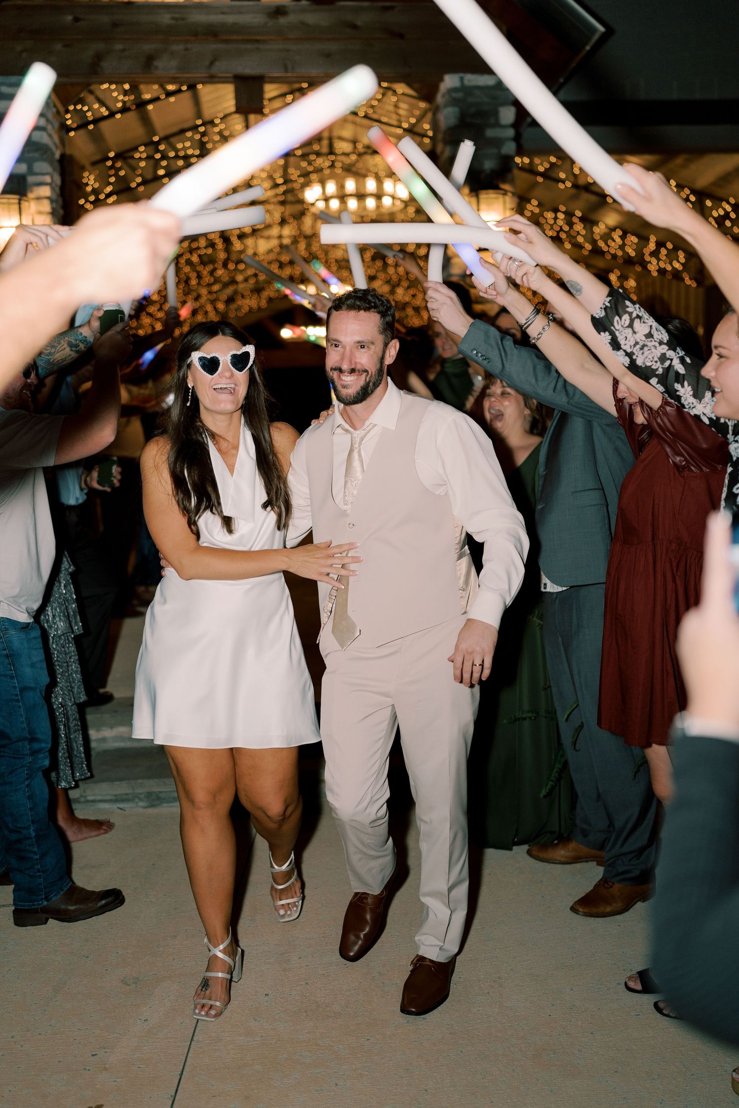 Wedding guests dance and celebrate on the dance floor during a lively reception party.