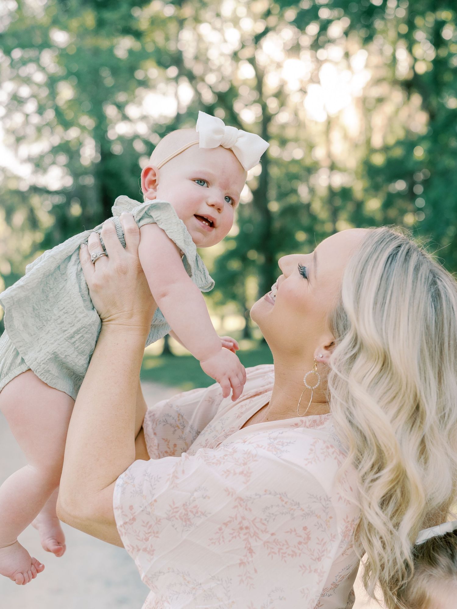 Loving family moment captured in outdoor portrait session with sunset lighting.