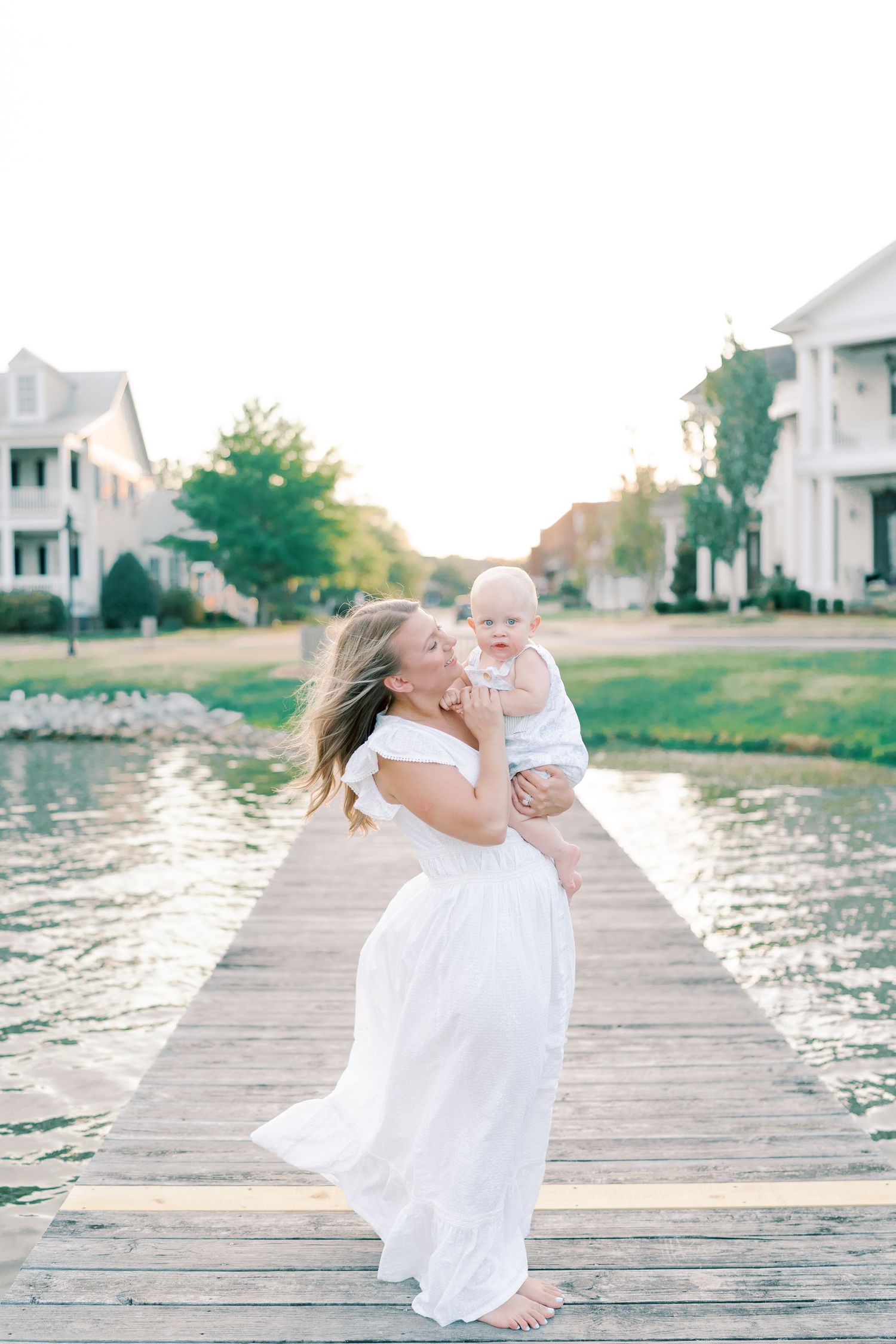 Playful family moments captured on a waterfront dock during golden hour.