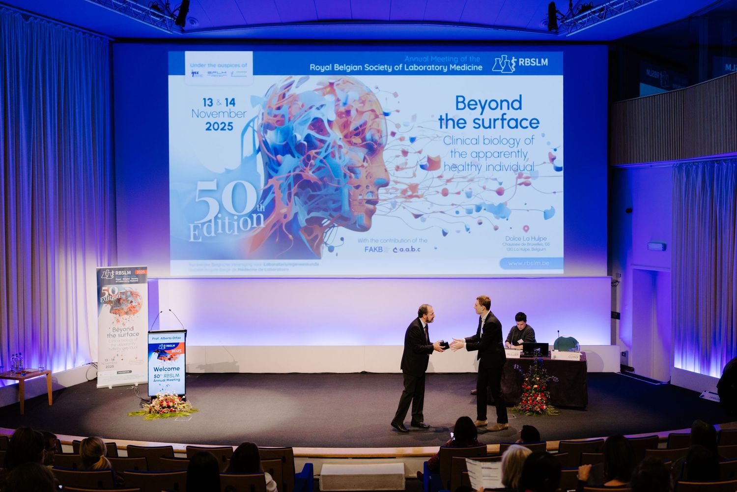 Speakers on stage at Royal Belgian Society of Laboratory Medicine 50th edition conference.