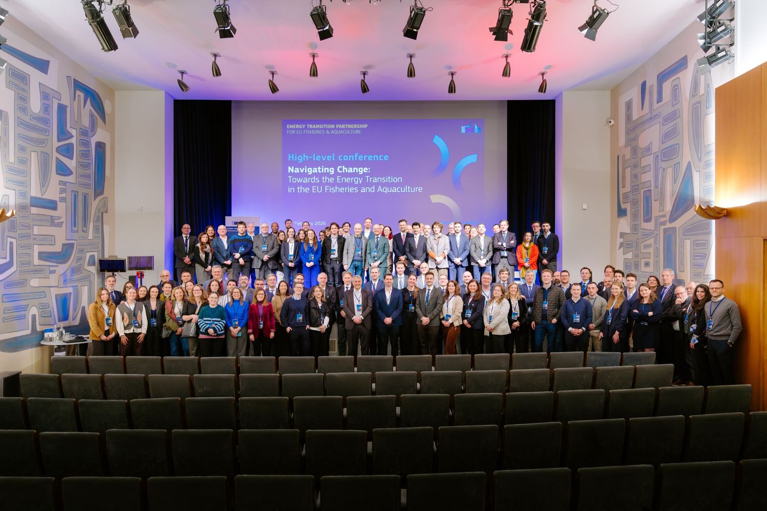 Large group photo of conference attendees on stage at Navigating Change fisheries event.