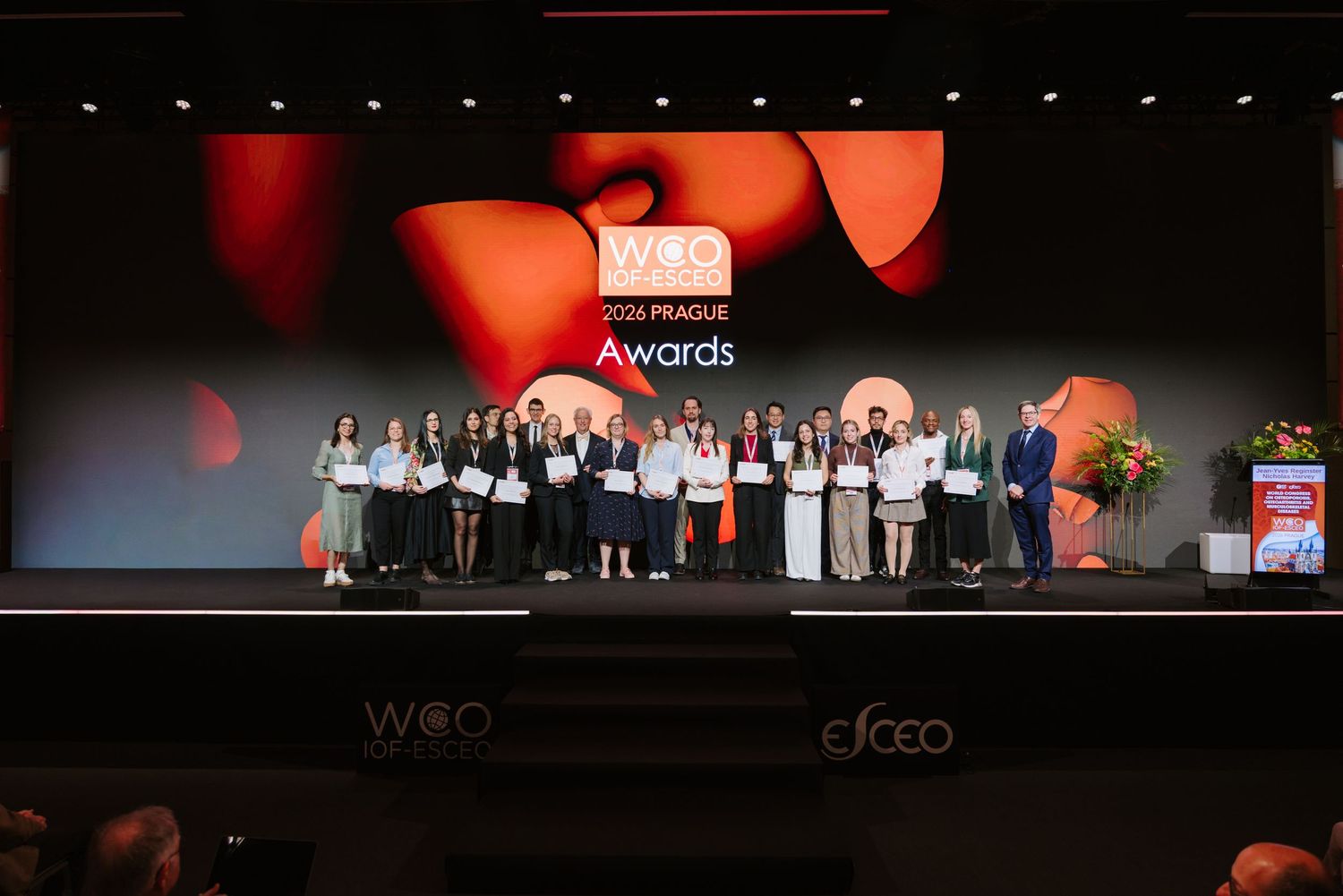 Award winners pose on stage at the WCO Prague Awards ceremony in a concert hall.