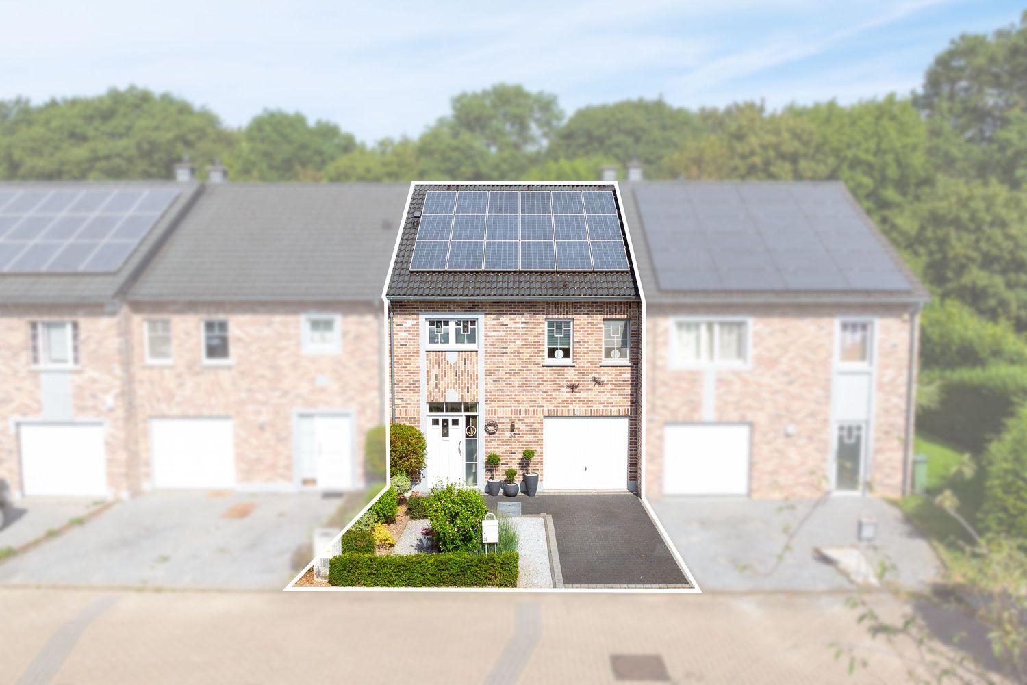 Brick terraced house with solar panels on roof, white garage doors, and landscaped driveway in a residential neighborhood.