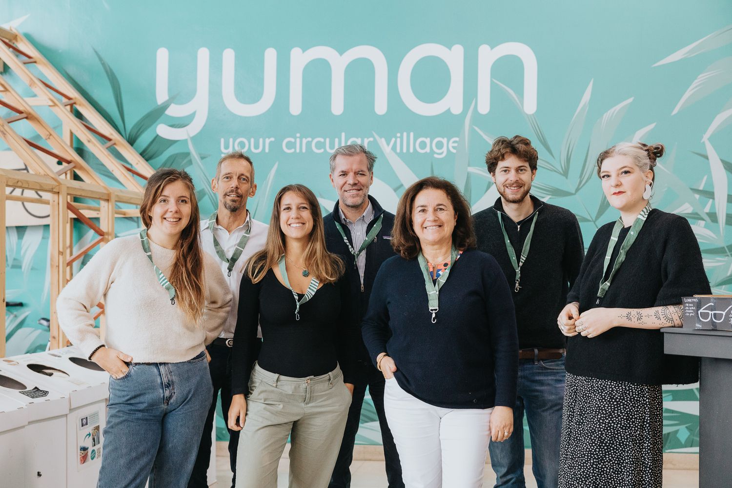 Team of seven people posing together in front of Yuman circular village sign.