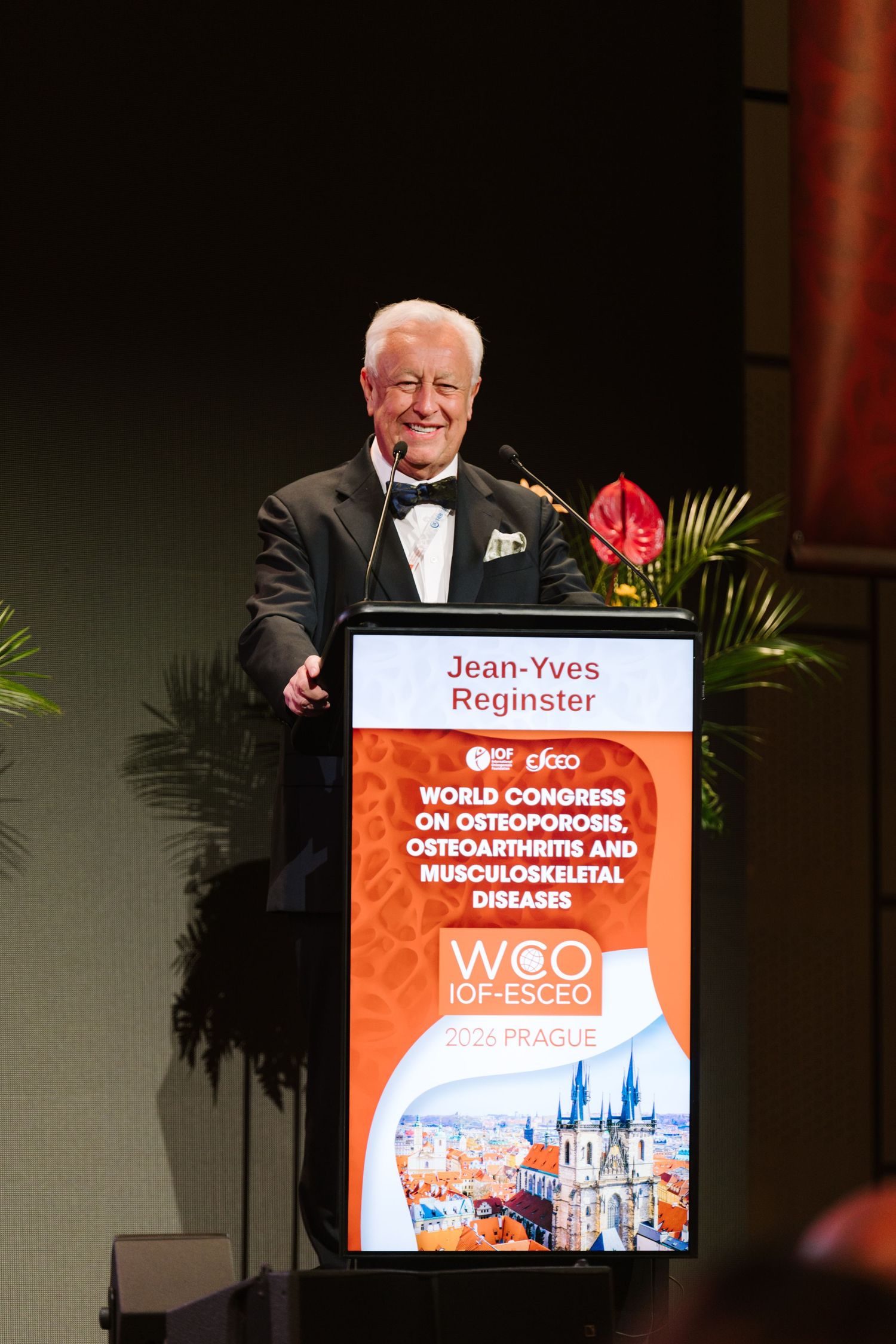 Jean-Yves Reginster speaks at WCO IOF ESCEO World Congress on Osteoporosis in Prague at a formal podium.
