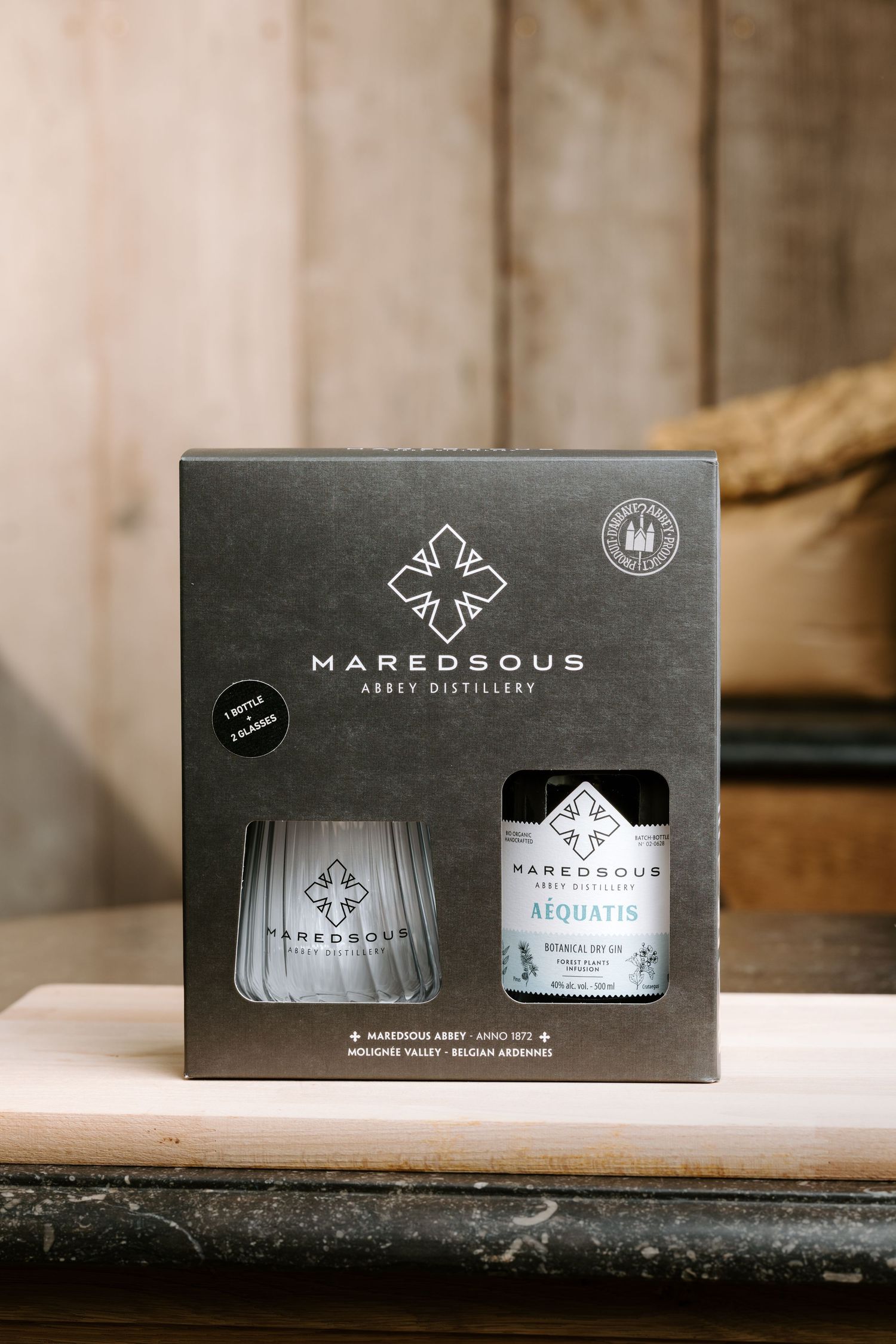 Maredsous Abbey Distillery Aequatis botanical dry gin gift set with branded glass in elegant gray packaging.