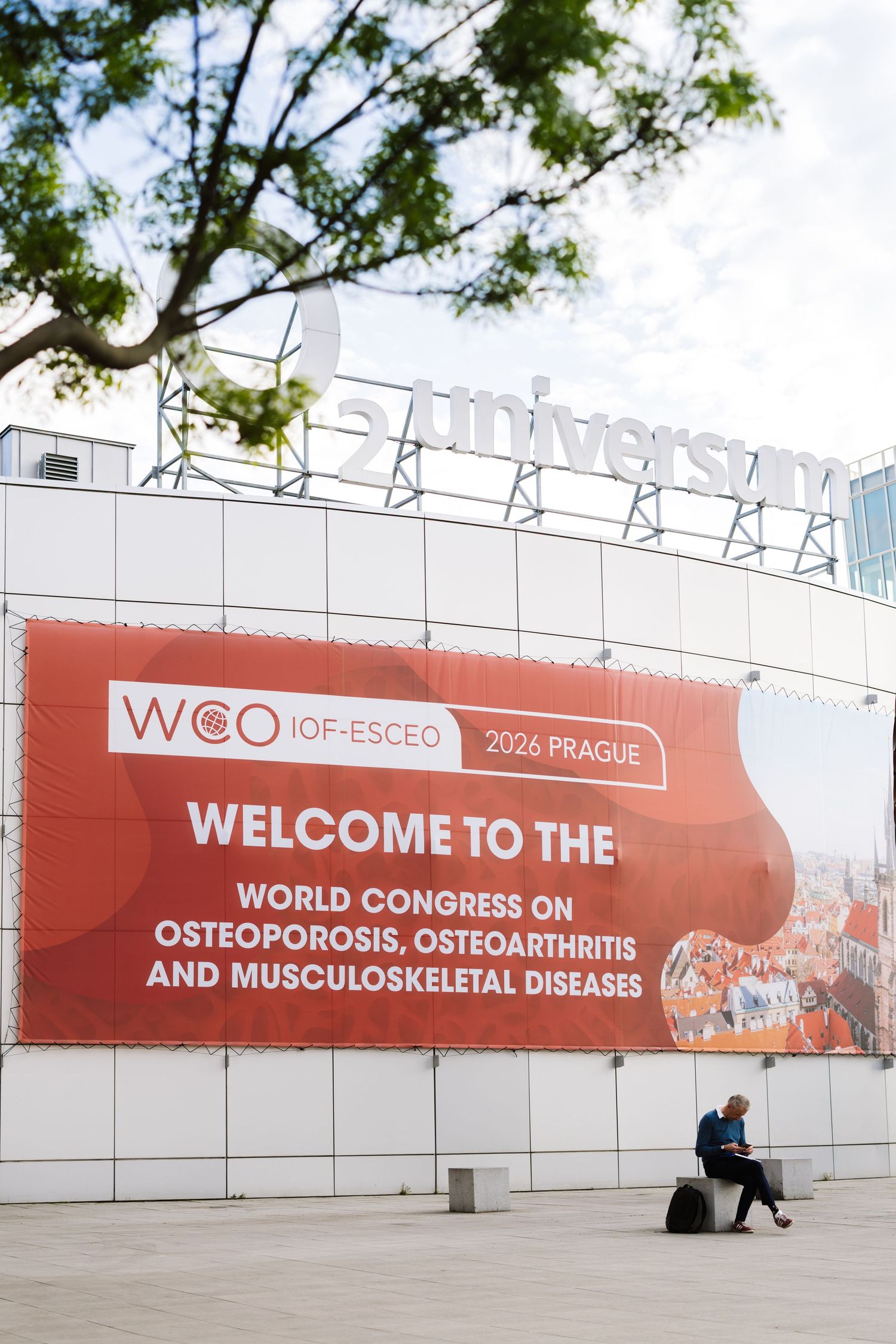 WCO IOF-ESCEO 2026 Prague World Congress on Osteoporosis banner on building exterior.