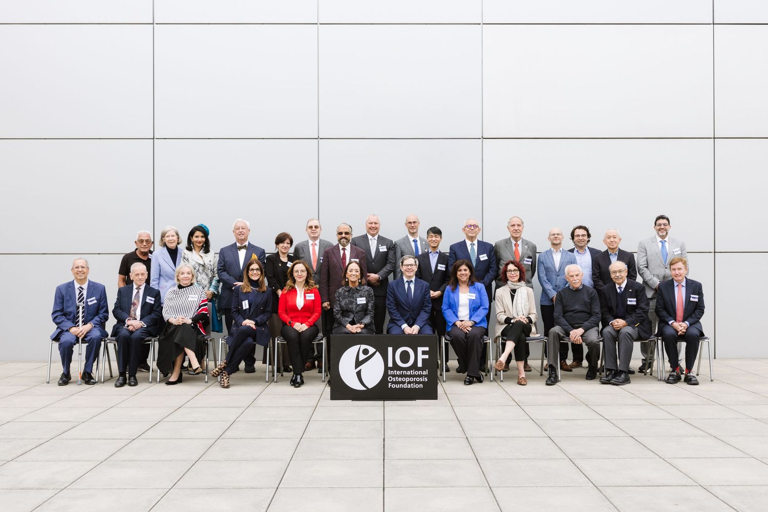 Large group of IOF organization delegates posing formally for official conference group photograph.