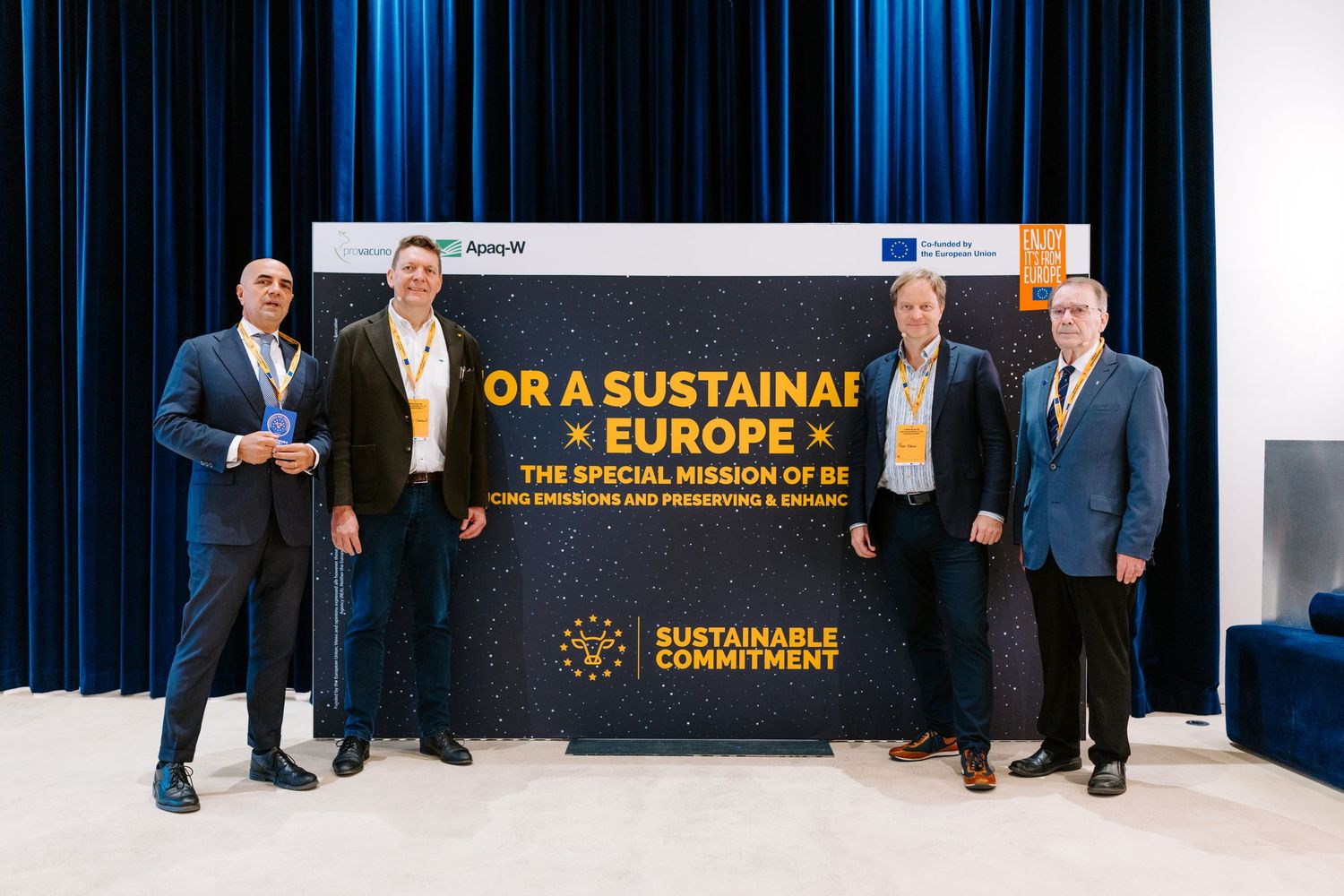 Four men posing beside Sustainable Commitment banner for a sustainable Europe initiative.
