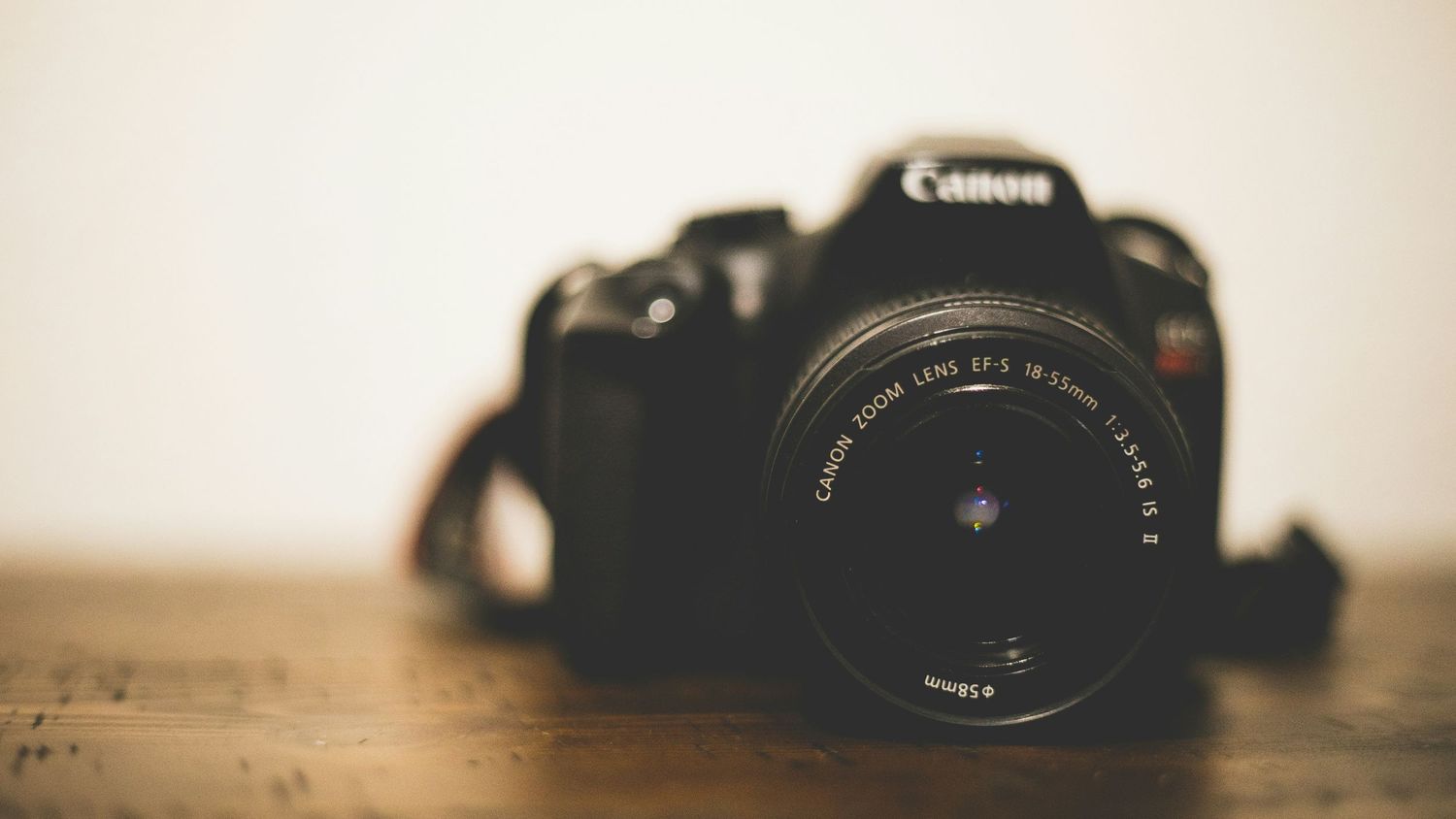 Canon camera lens and equipment arranged in a vintage-style photography display. Lifestyle Photographer in St Charles County and O'fallon MO