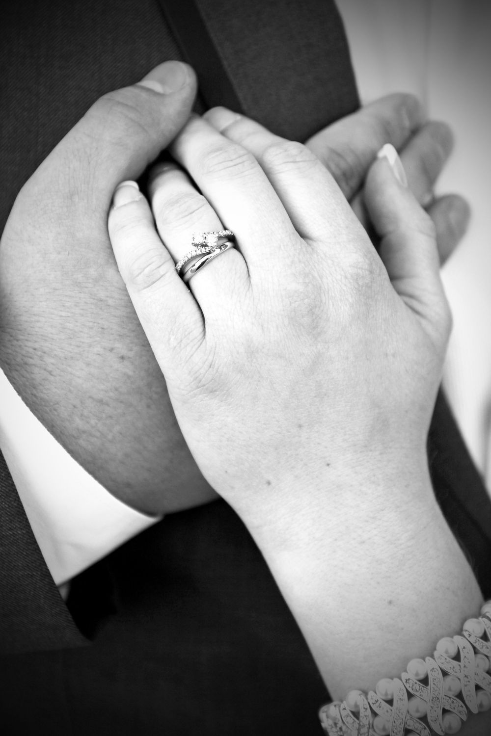 Wedding portrait in St. Peters, Missouri of close-up black and white wedding ring, bride and groom portrait in St Charles County.