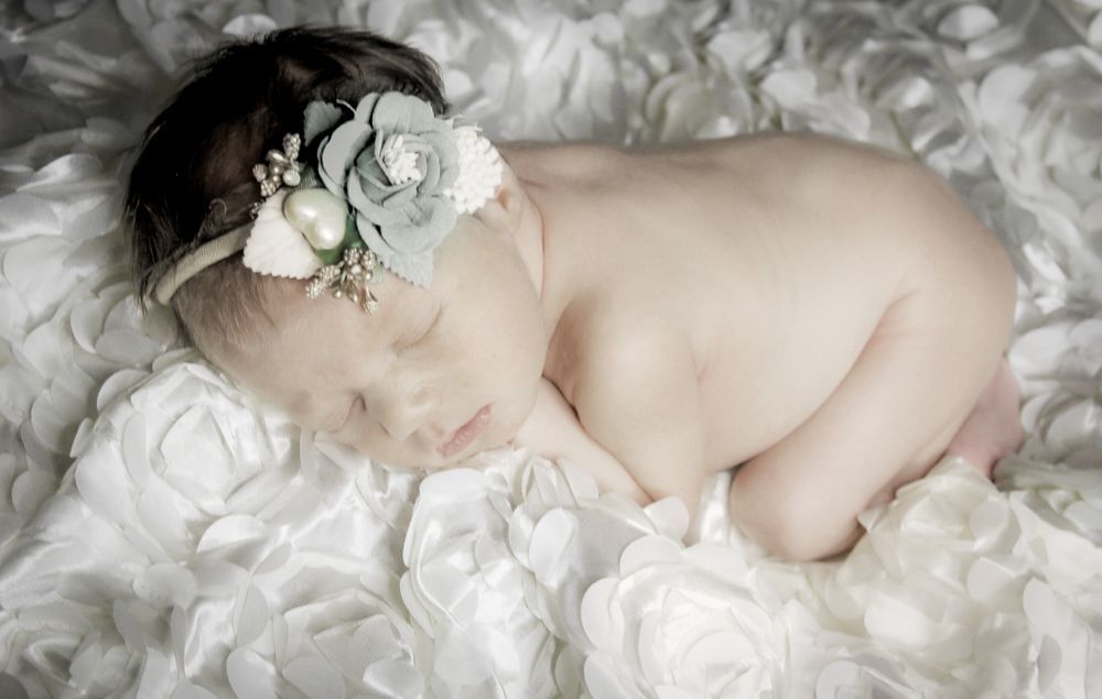 Newborn lifestyle photography in a natural, relaxed home setting in O’Fallon, MO.