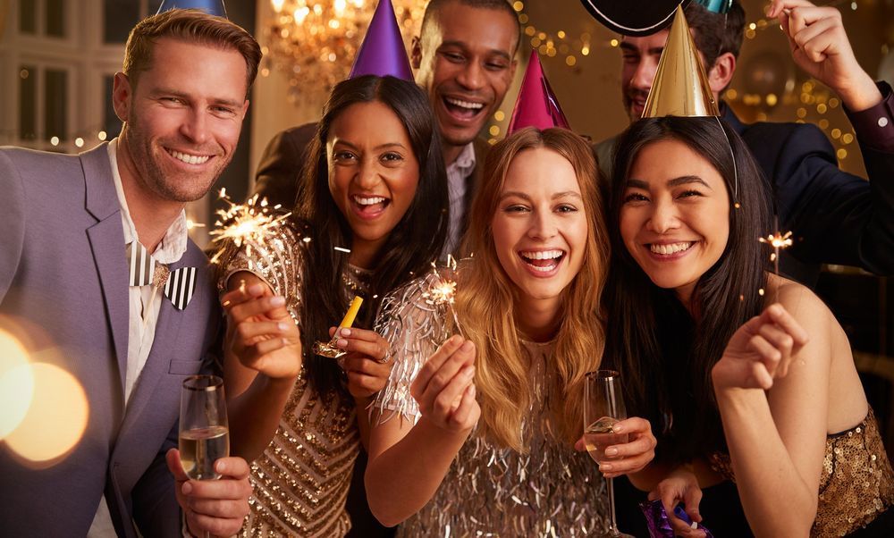 Photo Booth of Friends celebrating with sparklers at an elegant party with festive lighting in Saint Charles County, Missouri.