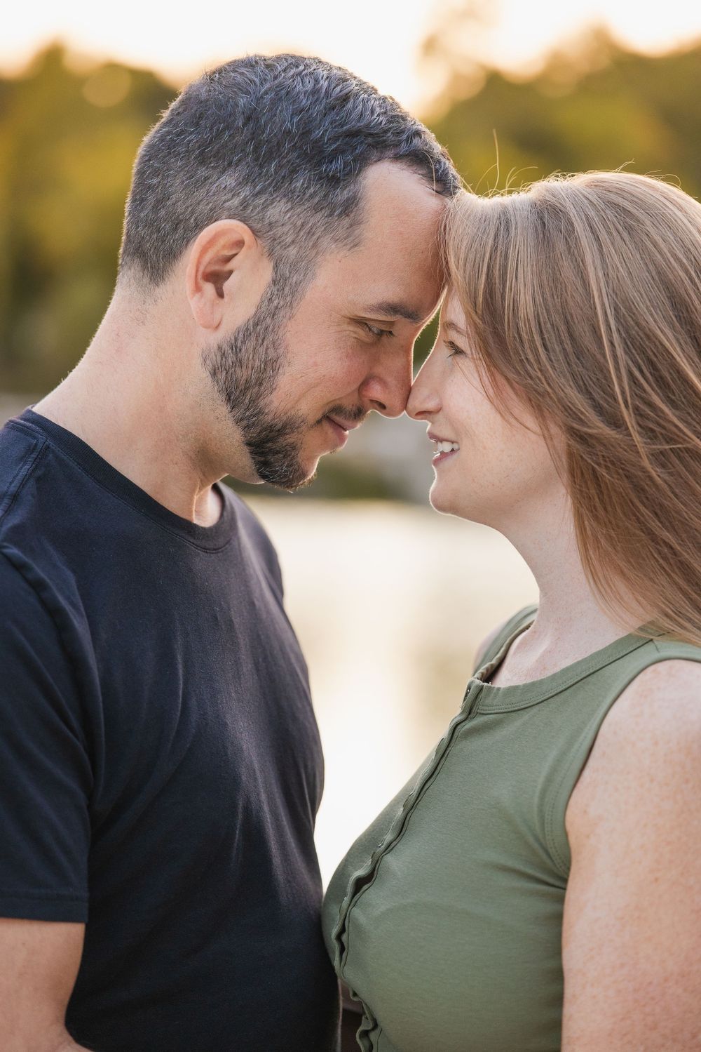 Couples photo session in Saint Charles County of iIntimate romantic moment captured between two people at sunset. Golden hour photography.