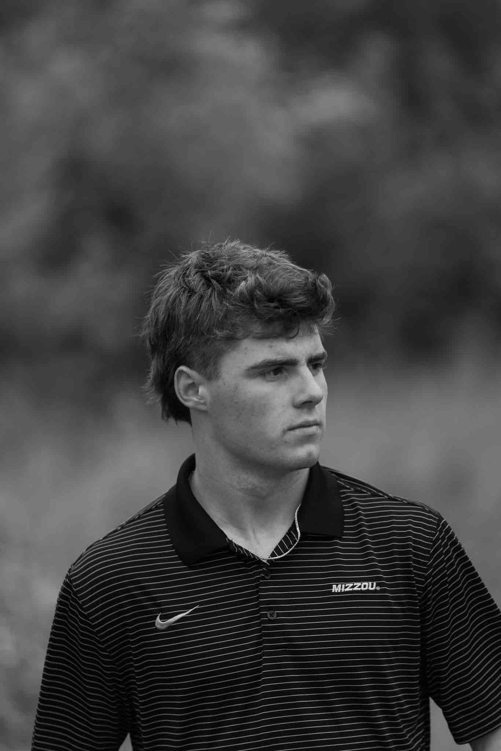 Francis Howell senior photo session in Saint Charles County of Black and white portraits of person in Nike striped polo shirt.