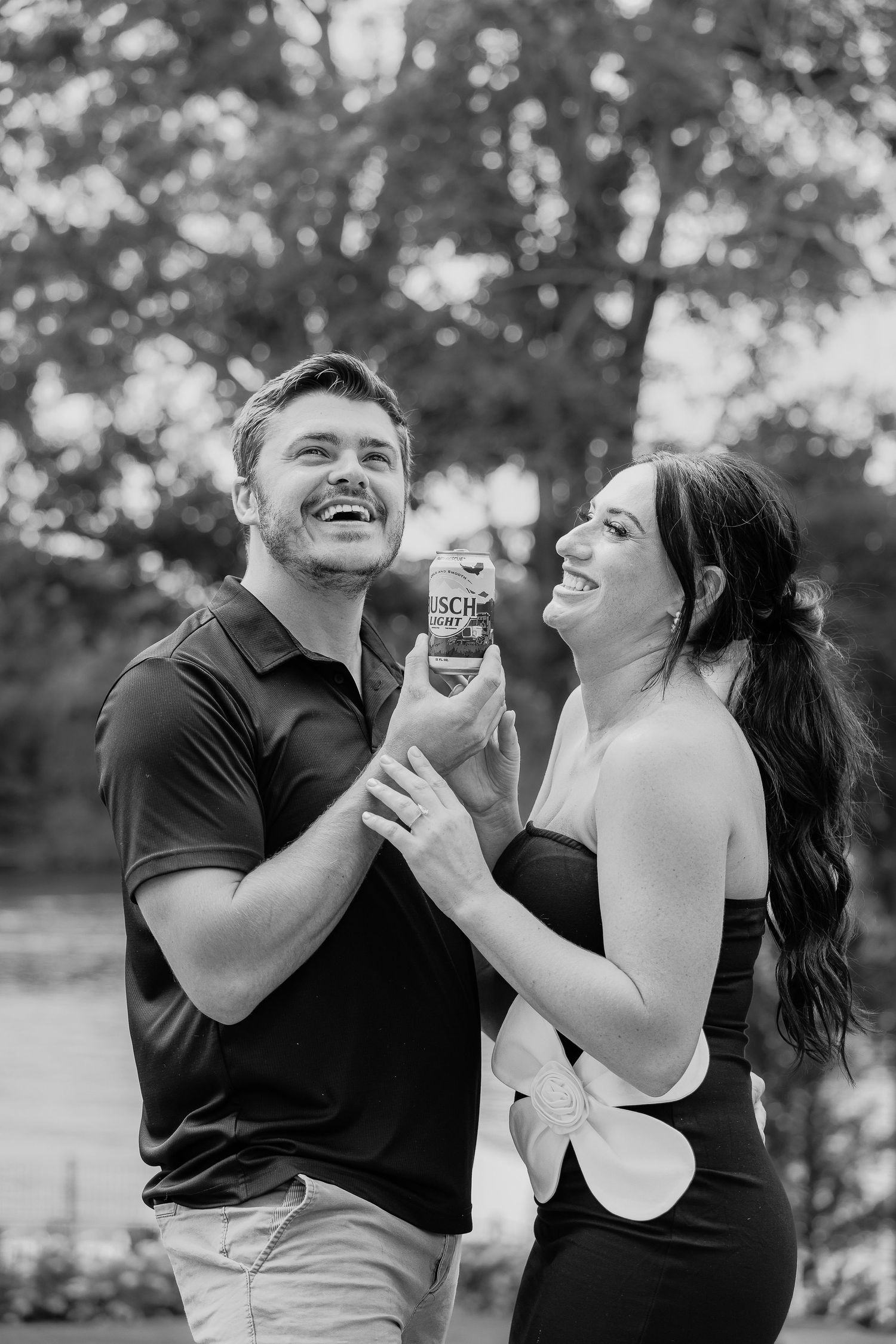 Couple photography in St Charles County laughing during outdoor photo session in Lake St Louis, Missouri. black and white photography in MO.