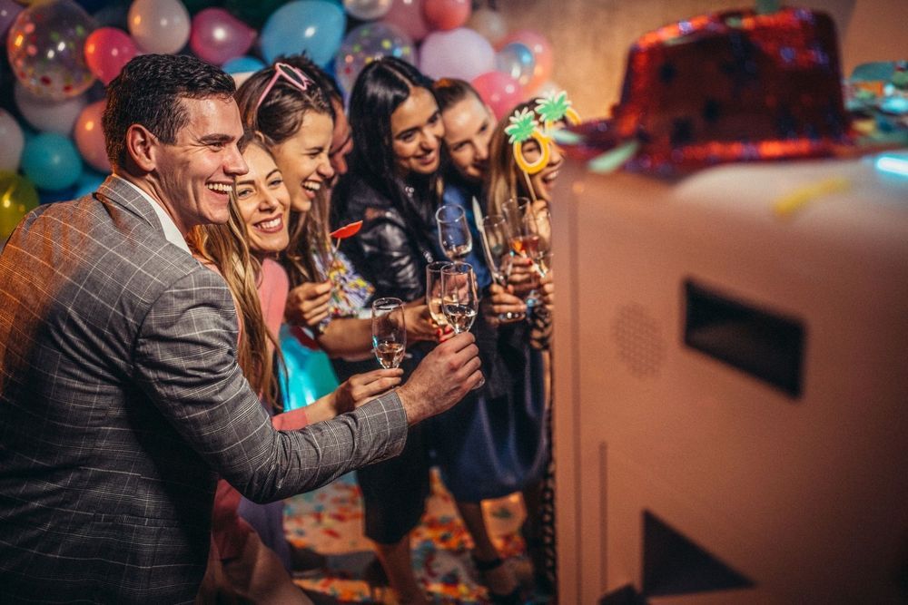 IPad Photo Booth rental in Saint Charles County, Missouri of high school reunion celebrating with colorful balloons and festive props.