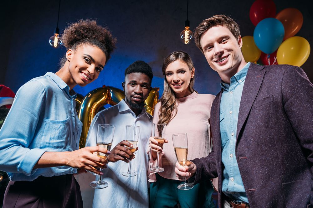 DSLR Photo Booth rental in Saint Louis, Missouri of co-workers with champagne glasses at a work party with colorful balloons in background.