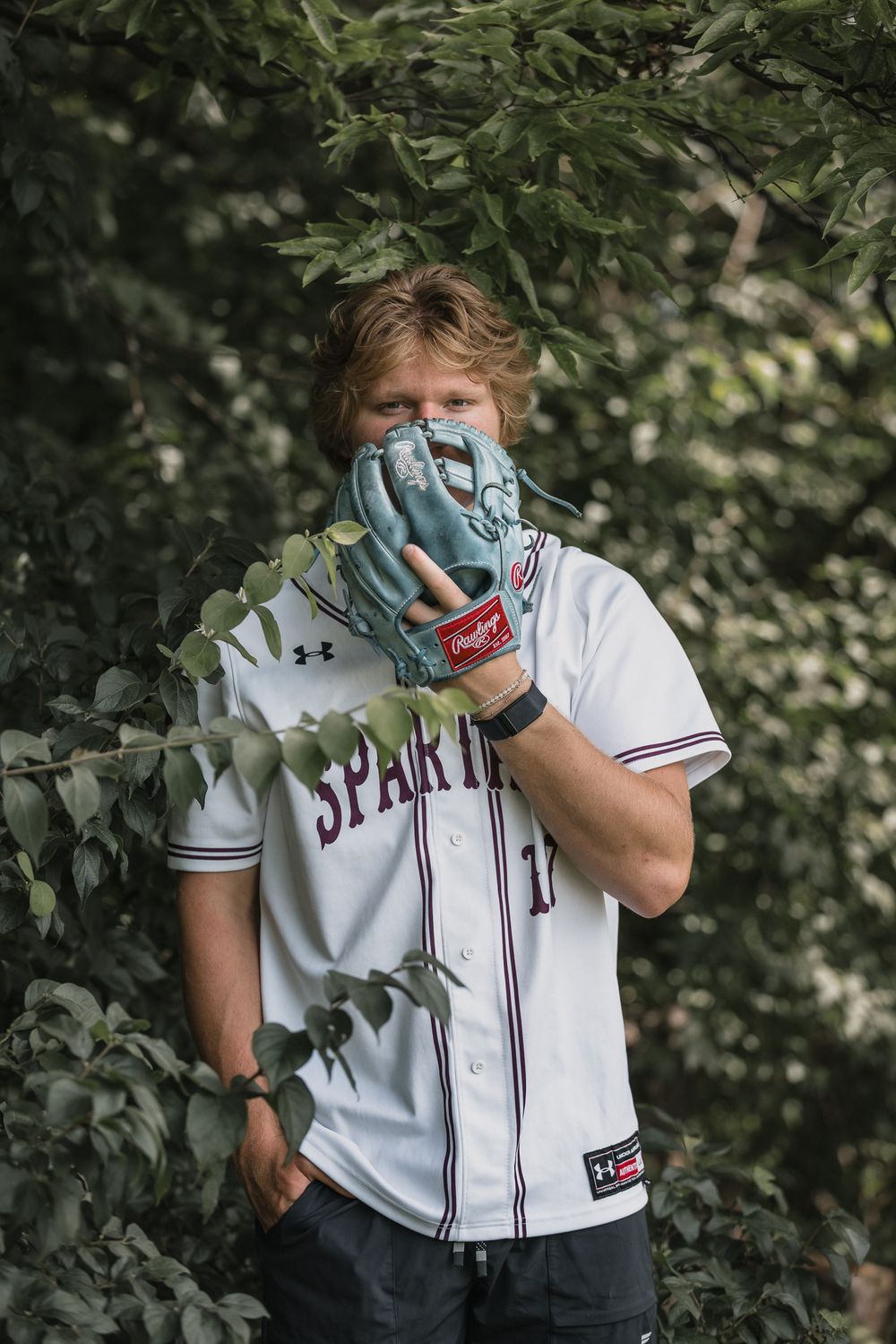 Senior portrait session in O’Fallon, Missouri highlighting personality, confidence, and natural style. Spartan jersey photo session.