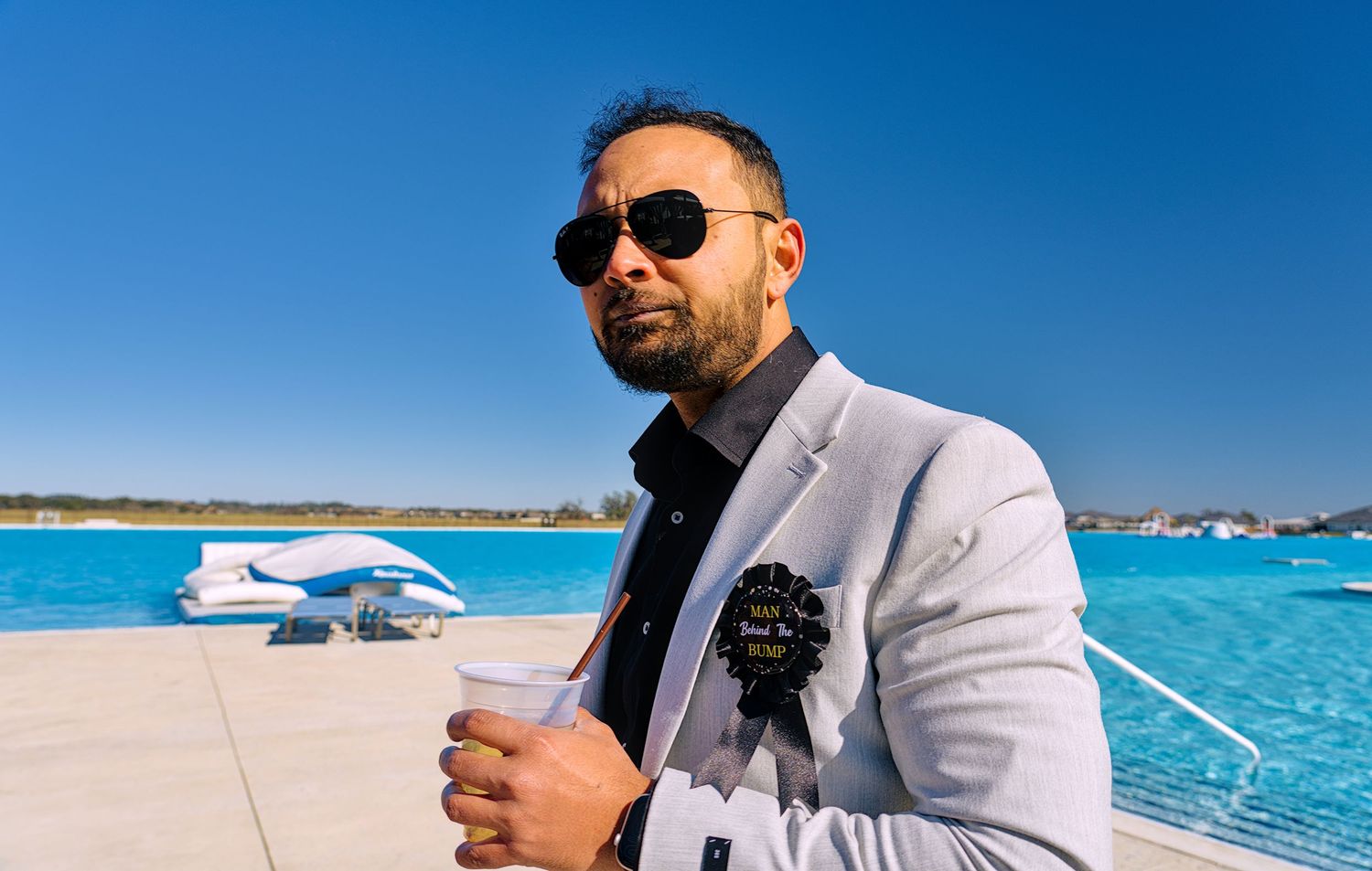 A scenic beach photoshoot with crystal clear turquoise waters and bright blue skies.