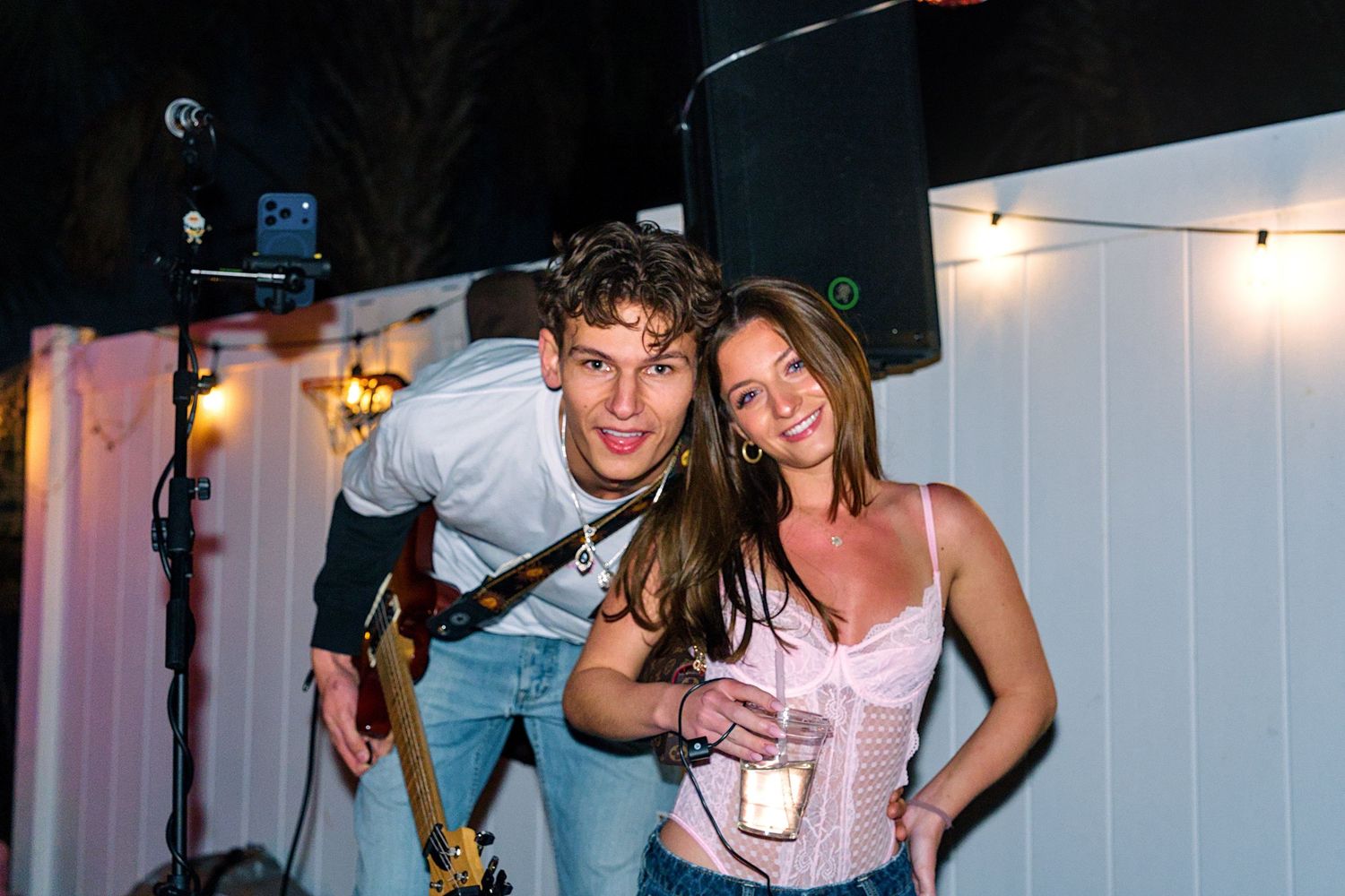 People dancing and having fun at a nightclub party with strobe lights and dark atmosphere.