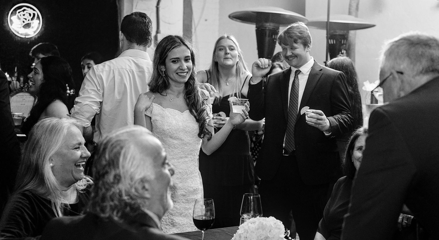Black and white wedding reception photos showing guests mingling and celebrating.