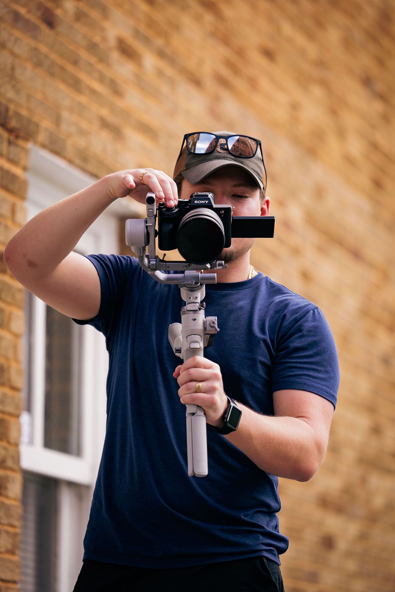 Photographer demonstrating different camera angles with handheld gimbal setup.