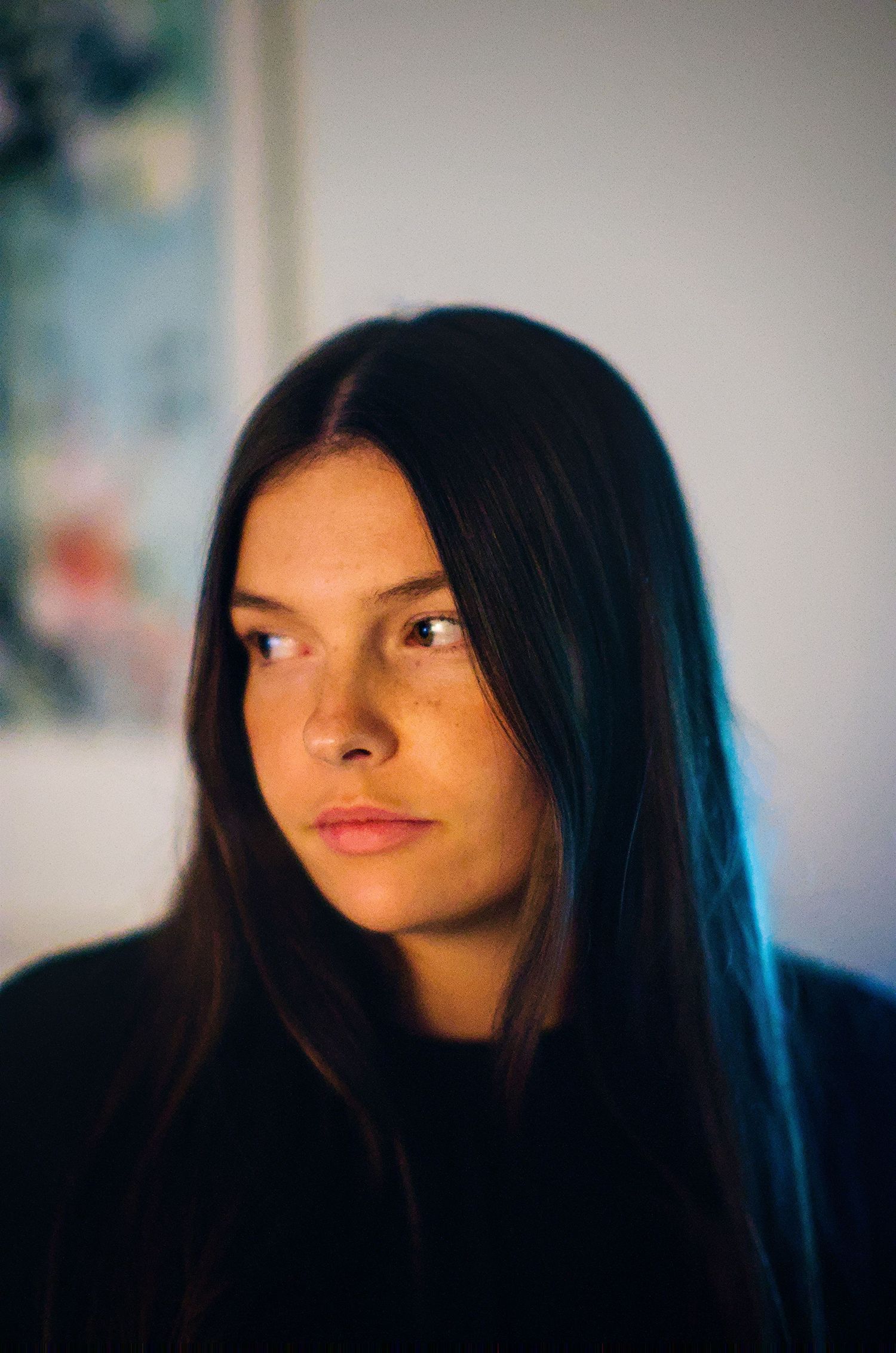 A series of five close-up portraits showing dark hair and dramatic side glances against a blurred background.