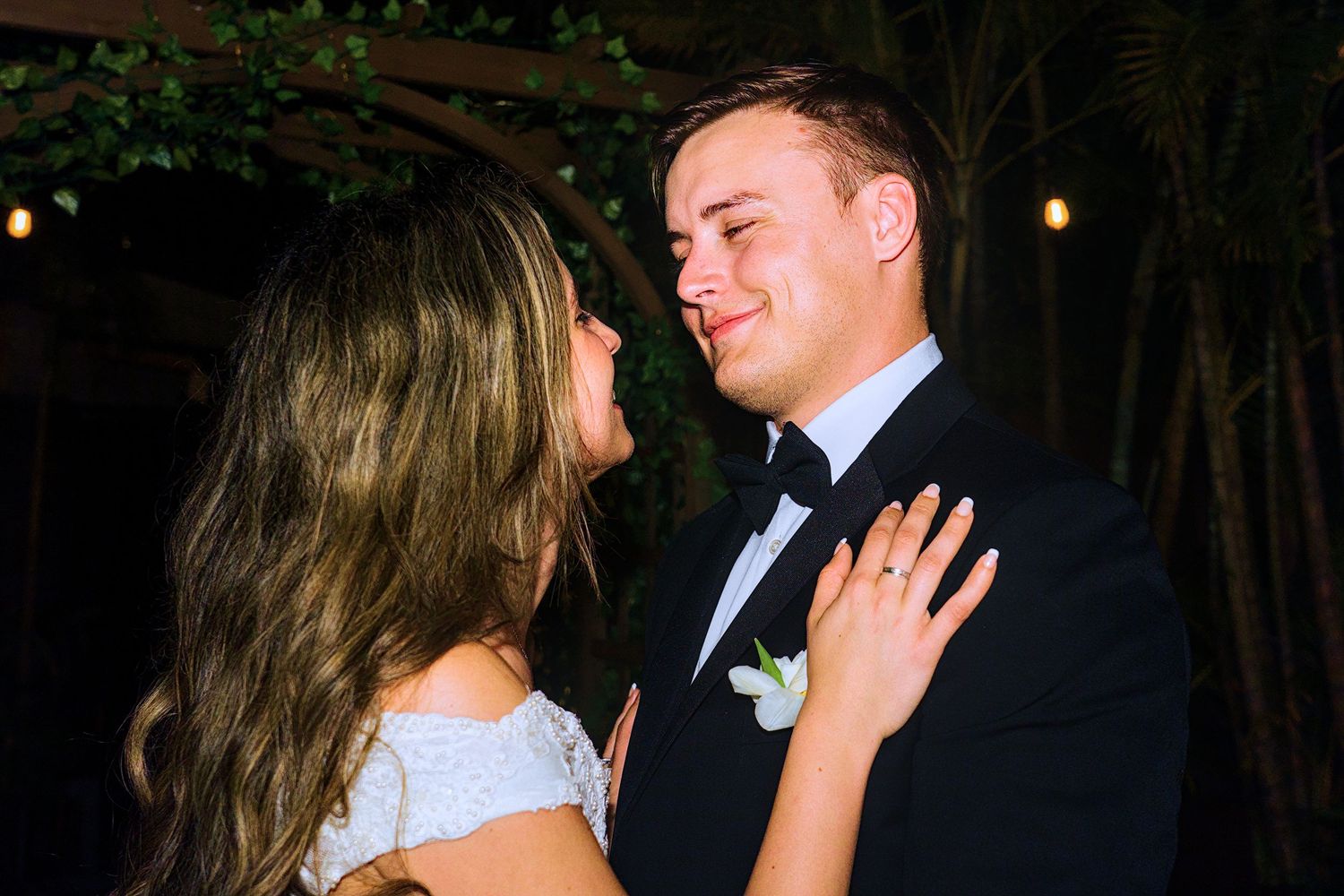 Evening wedding celebration with romantic lighting and tropical decor.