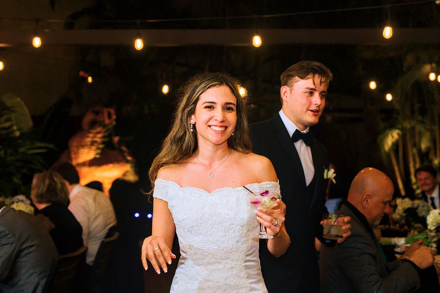 Wedding reception venue decorated with warm string lights creating a romantic ambiance.