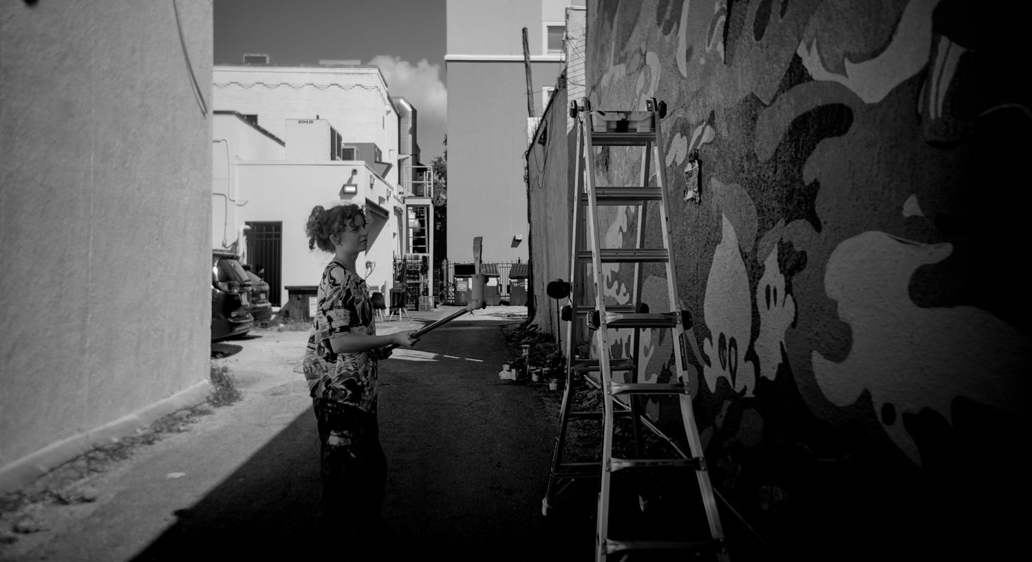 A black and white panoramic collage showing multiple street scenes and architectural details in an urban setting.