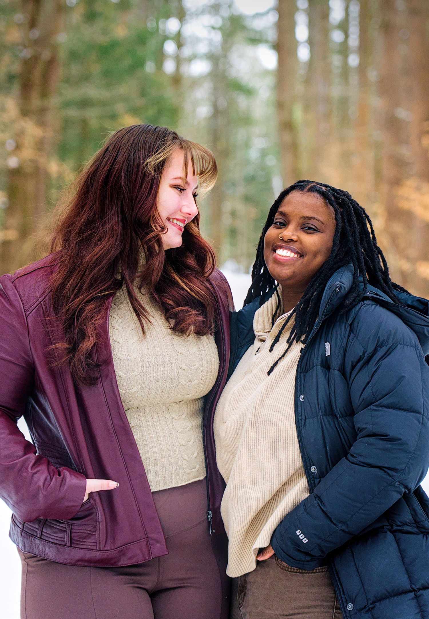 Four sequential photos showing two friends in winter coats laughing together outdoors in a wooded setting.