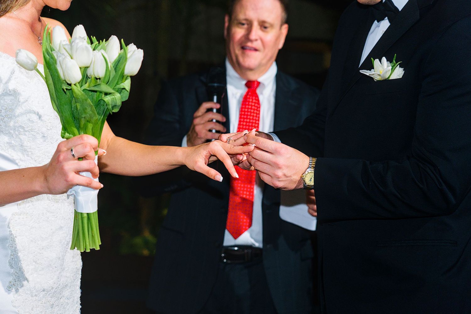 Wedding party celebrating with drinks and laughter at an elegant evening venue.
