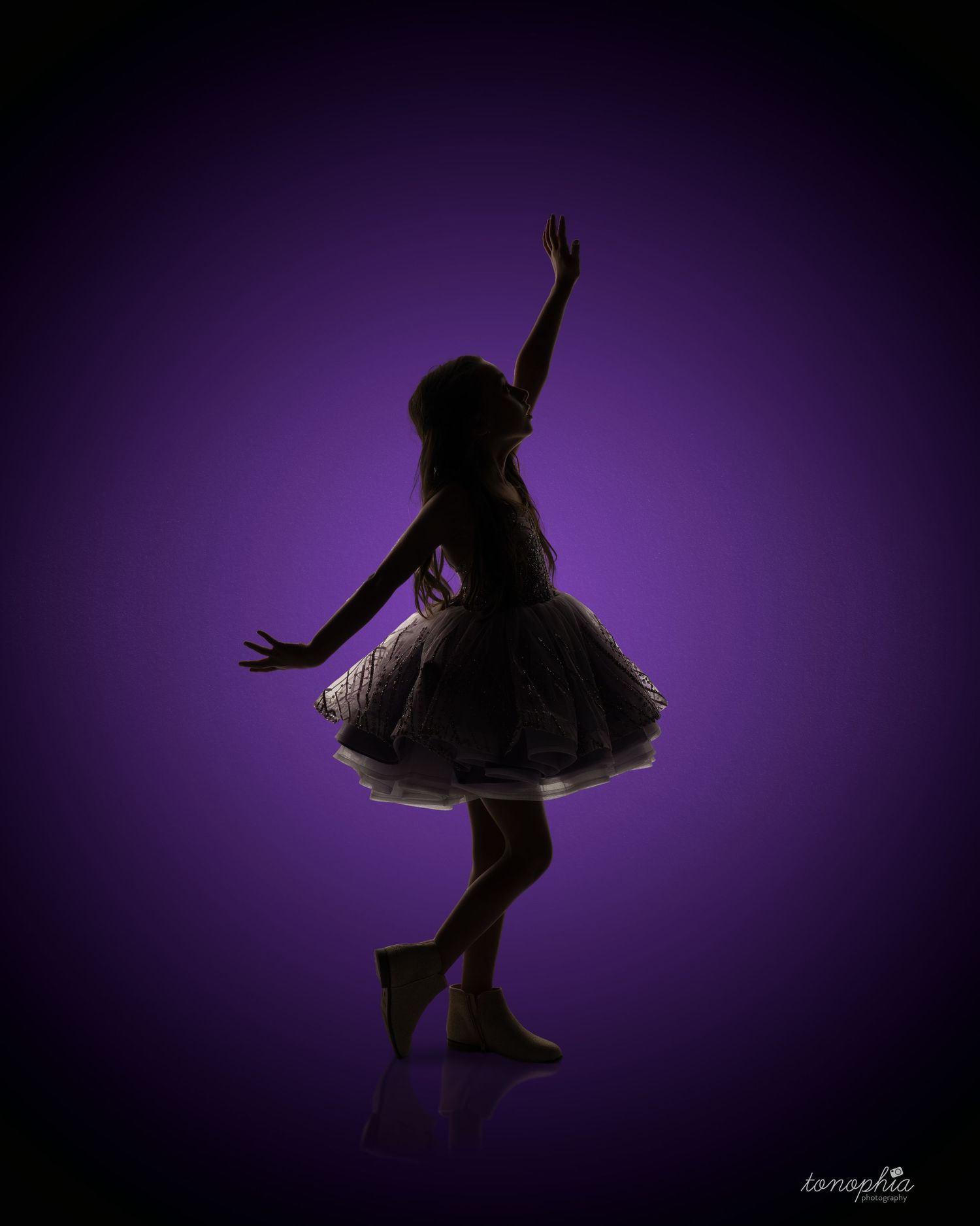 Silhouette dance poses against a deep purple studio background showing graceful movement.