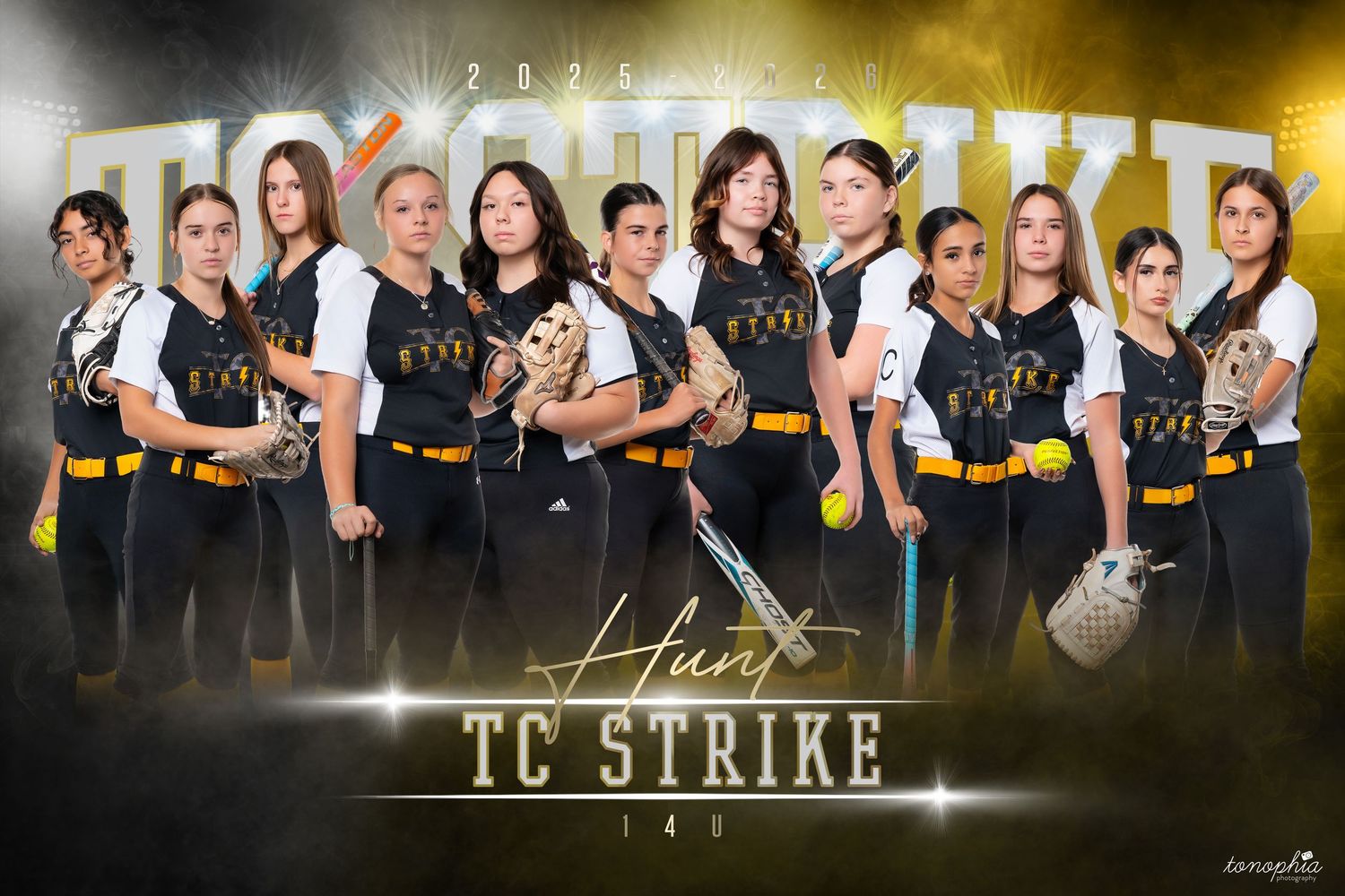 Group photo of a softball team in black uniforms against a dramatic dark background with lighting effects.