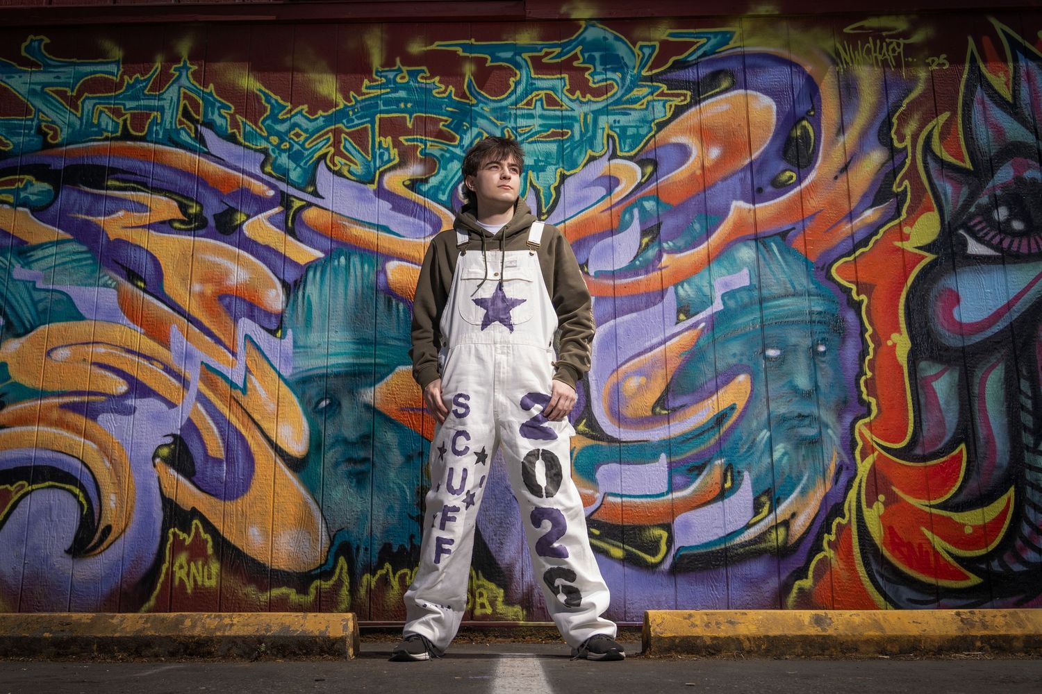 Street style portraits with colorful graffiti mural background in urban setting.