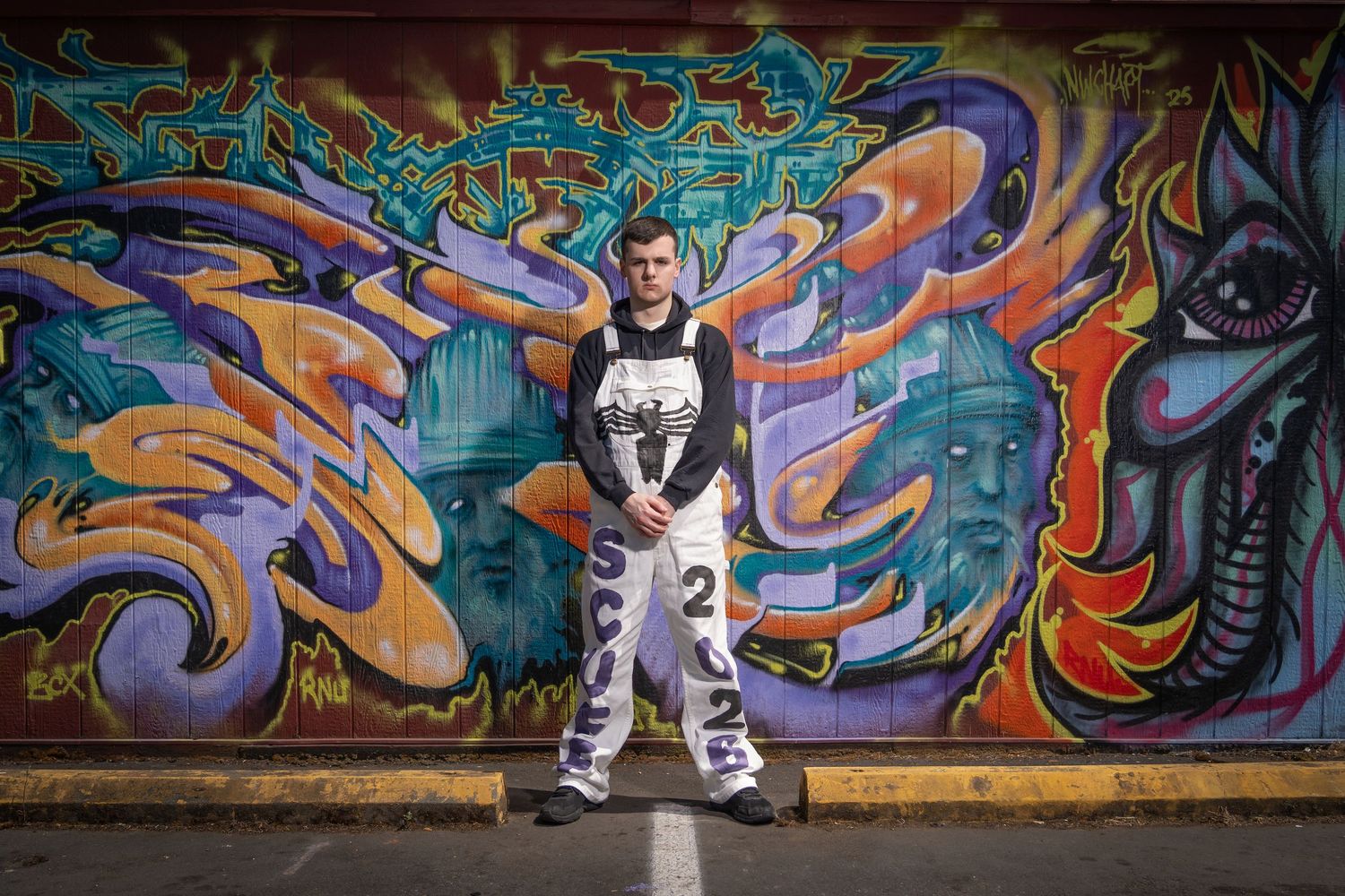 Wide angle shots showcasing colorful street art murals with dynamic poses.