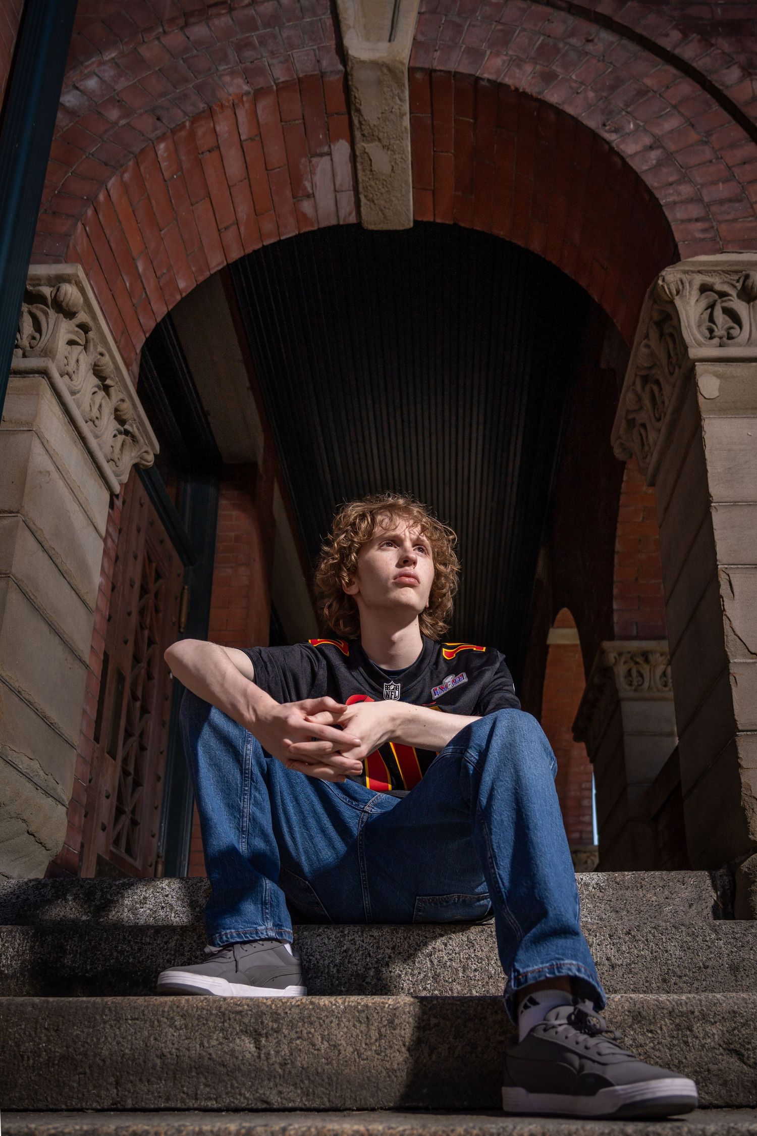 Moody portrait series taken under brick archways with dramatic shadows.