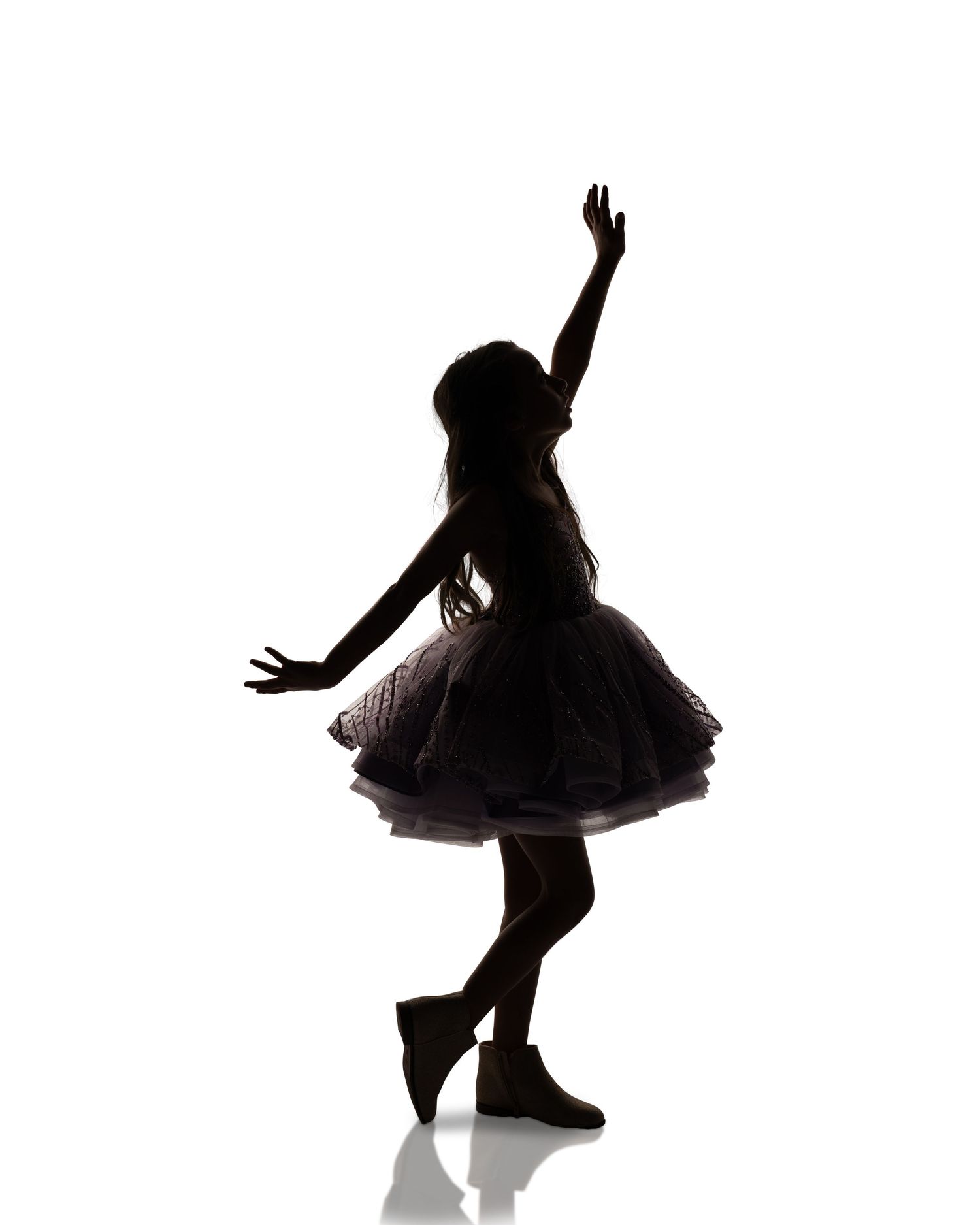 Silhouette sequence of a dancer performing expressive movements against white background.