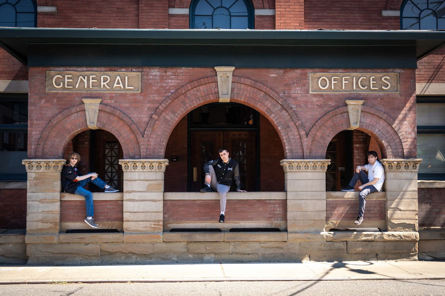 Sequential photos along a brick building with arched windows and architectural details.