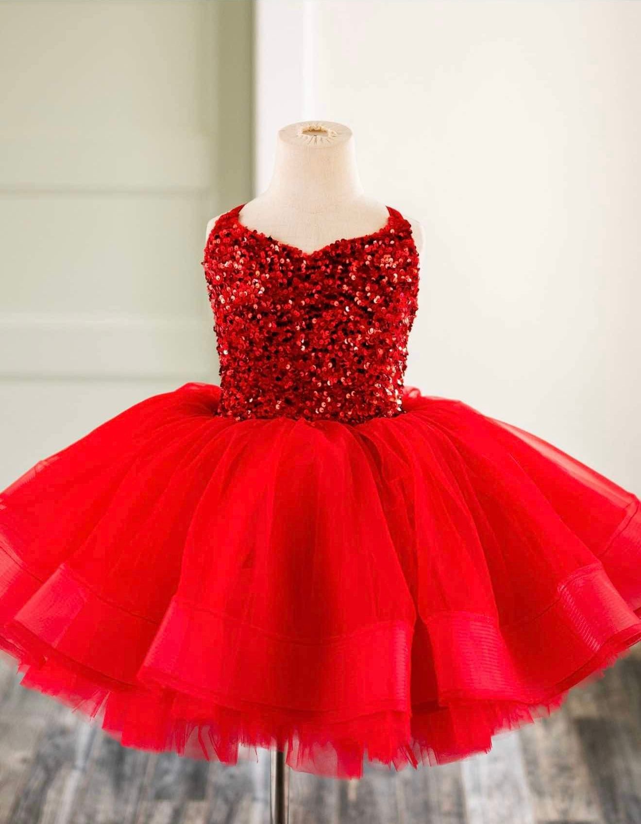 Bright red tulle party dress with sequined bodice displayed on mannequin.