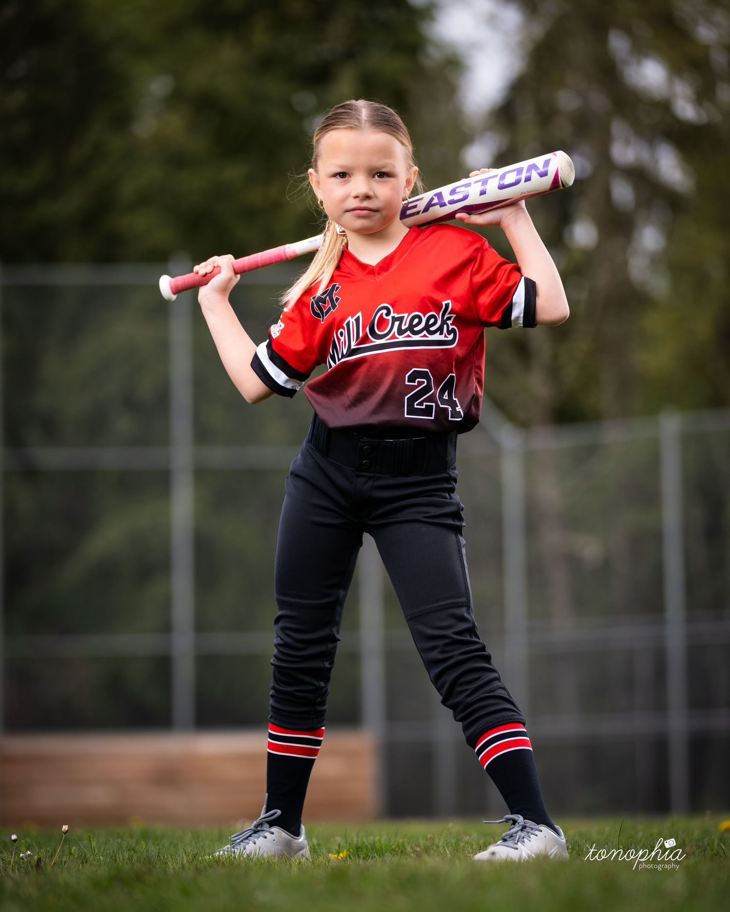 A series of four action shots showing a young softball player in a red and black uniform practicing batting stances.