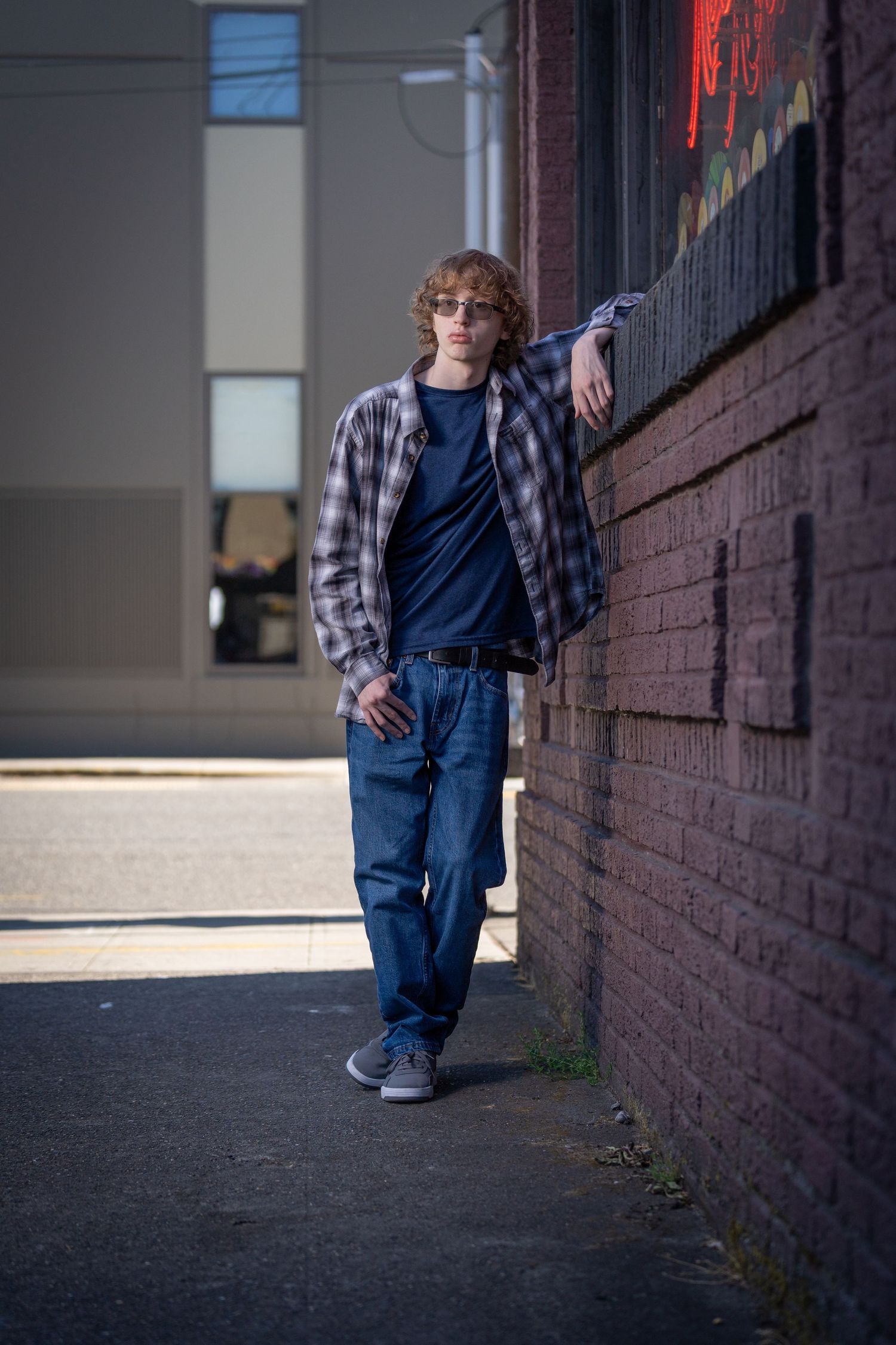Urban photography sequence showing movement along a brick wall in natural lighting.