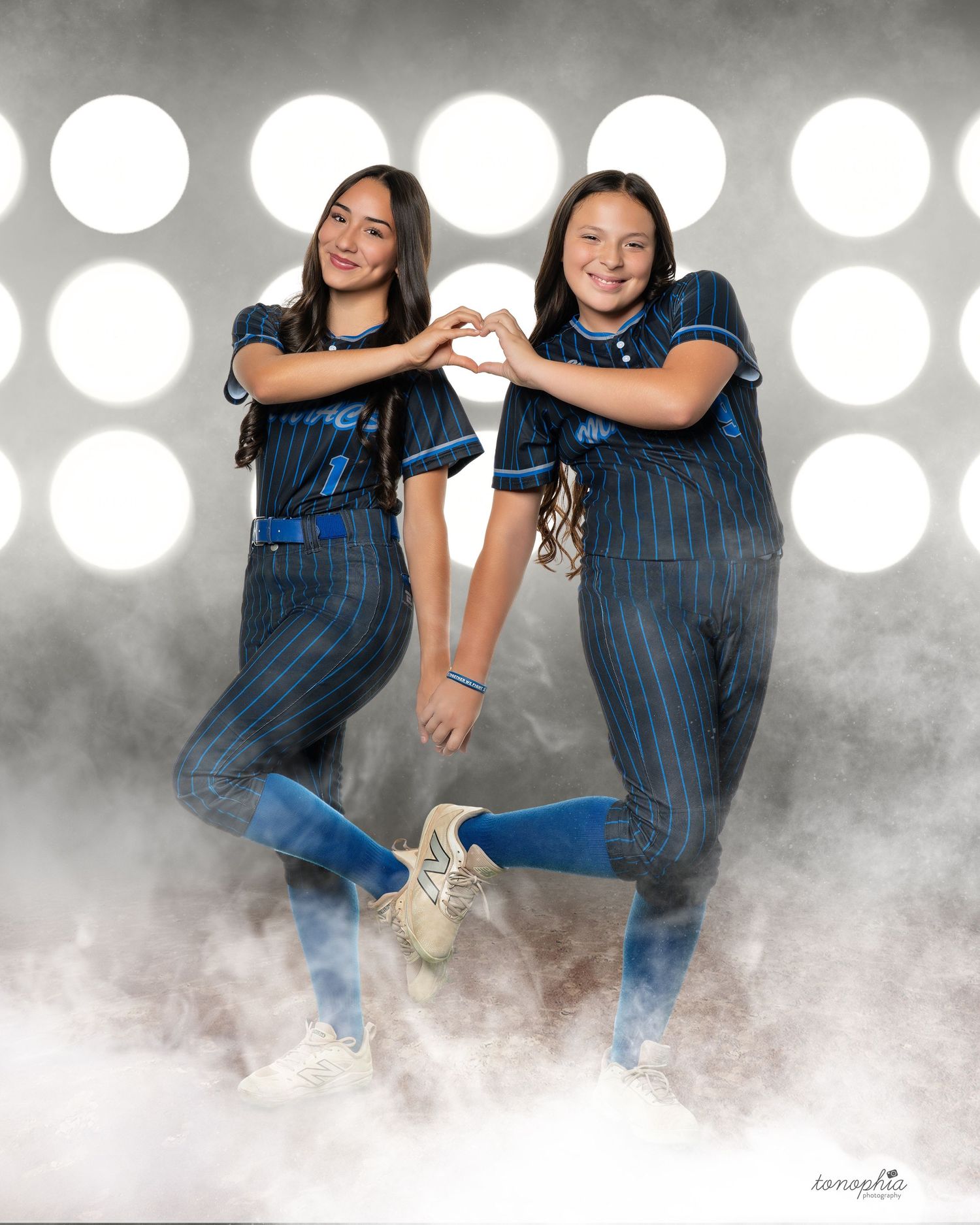 Multiple action shots of softball players in navy uniforms with dramatic smoke and lighting effects.