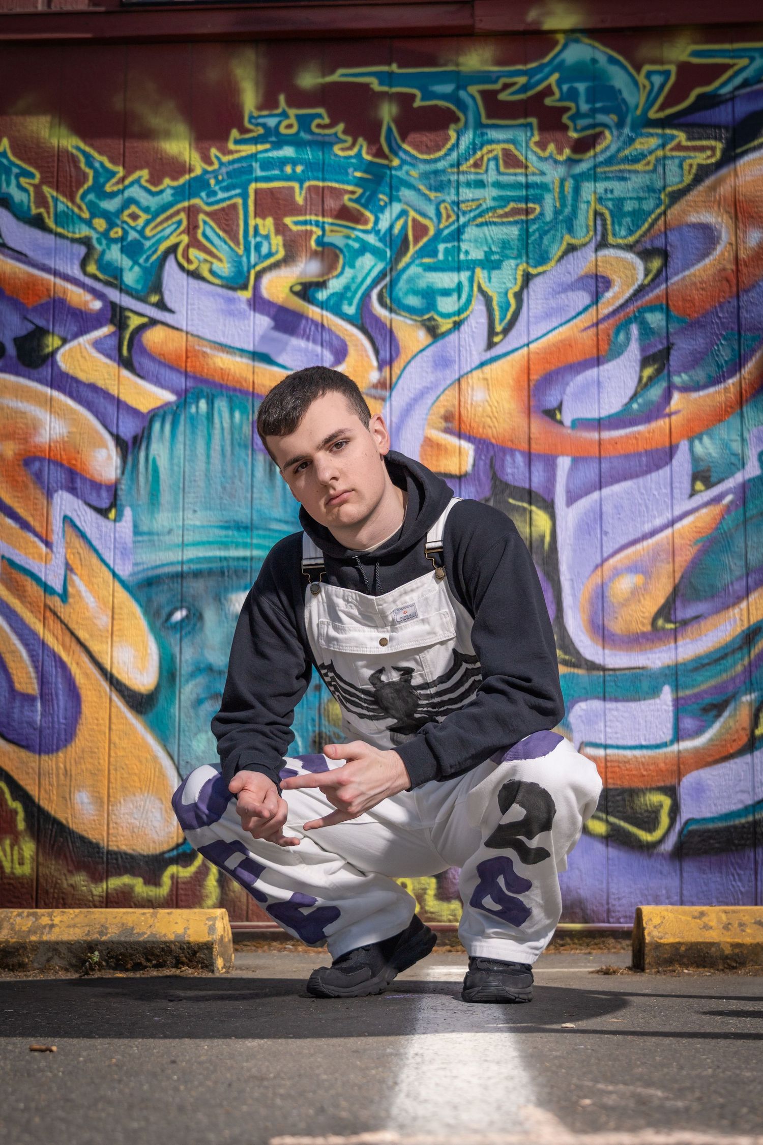 Street style photos against vibrant graffiti wall with blue and orange tones.
