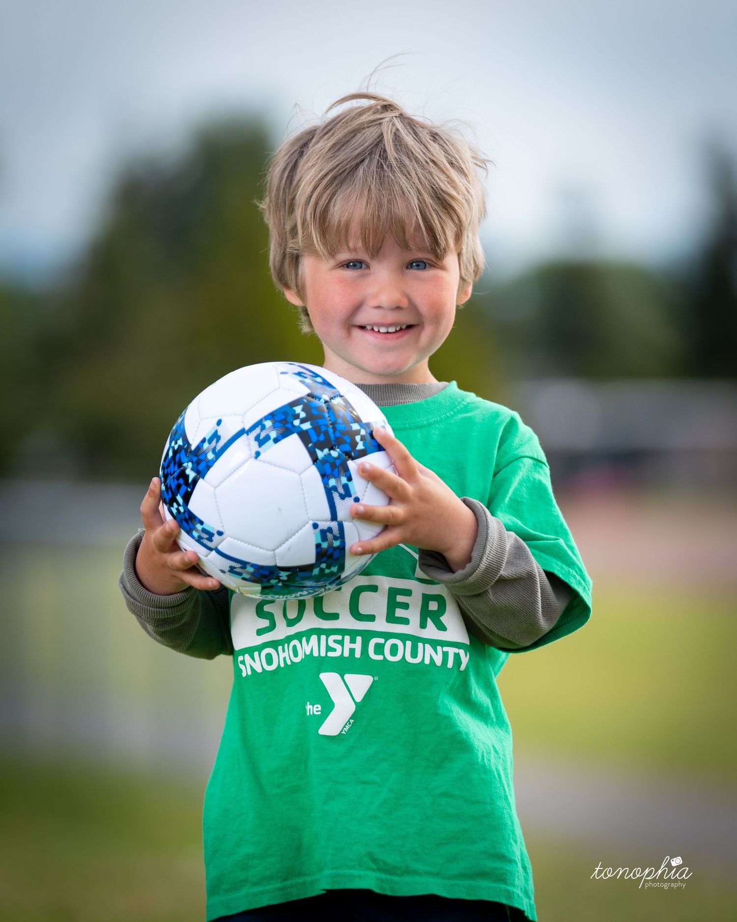 A series of photos showing a soccer ball being held up against a green background, with focus on the Snohomish County logo.