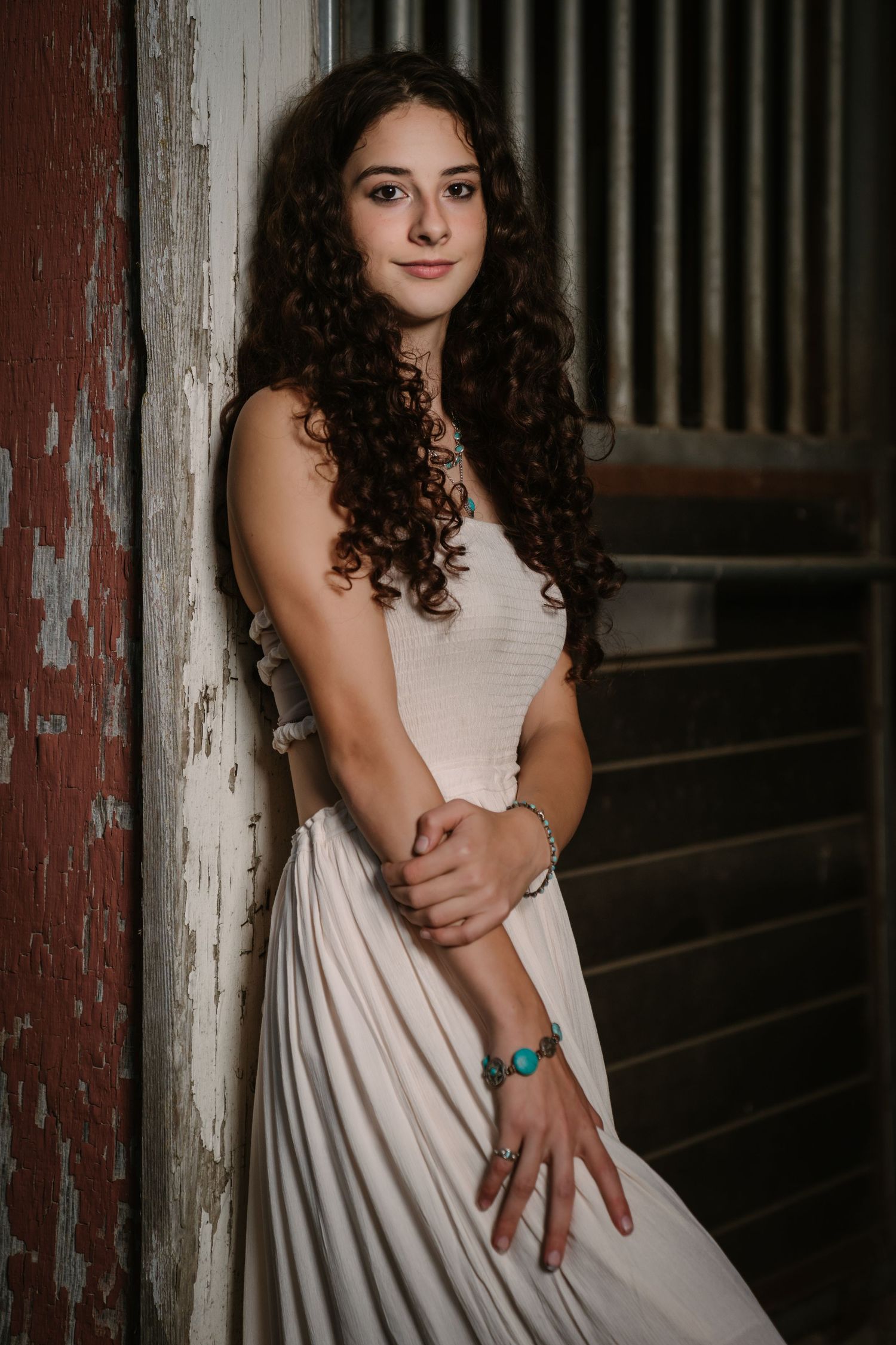 Portrait session in rustic barn setting with vintage wooden walls.